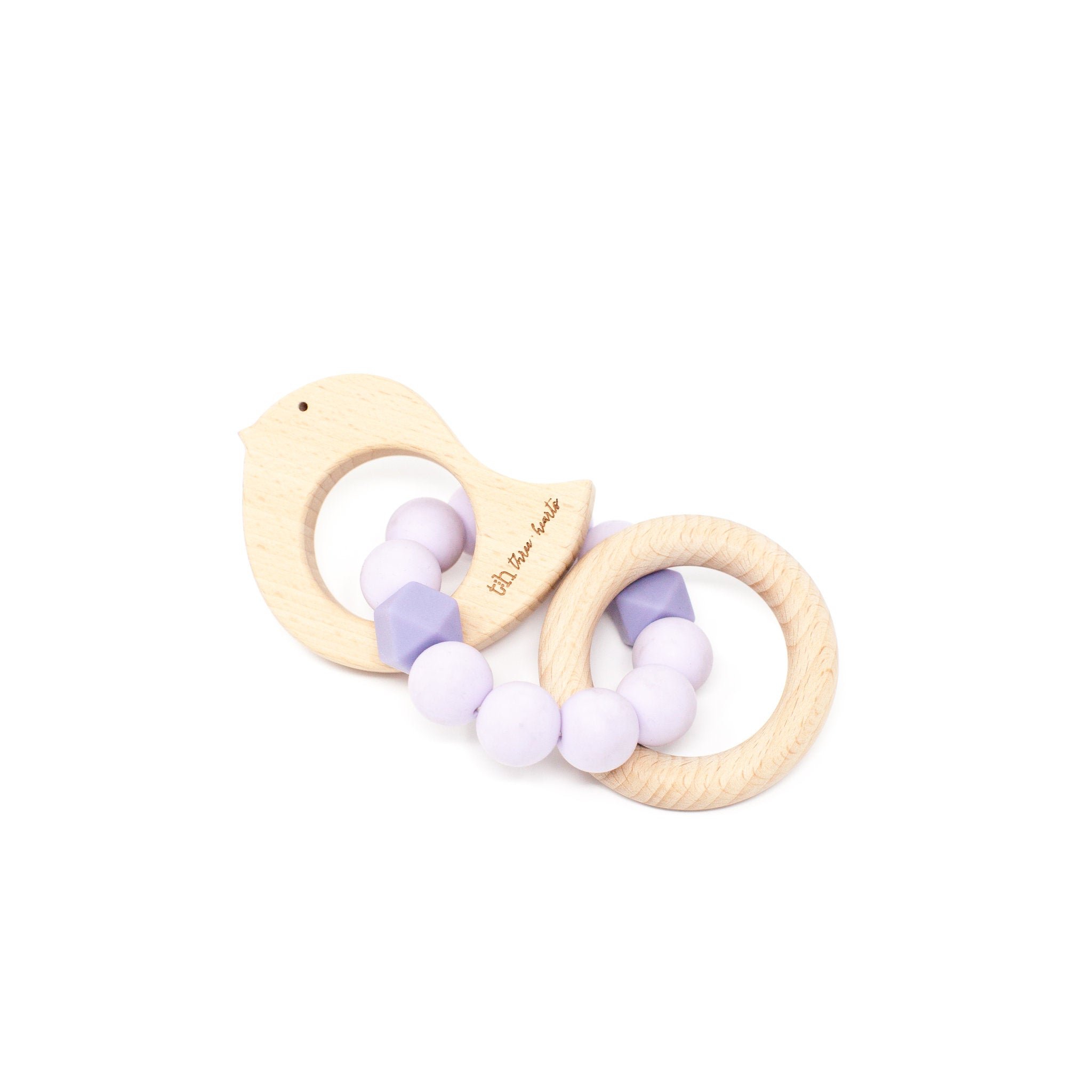 Wooden teething ring with purple and white beads on a white background