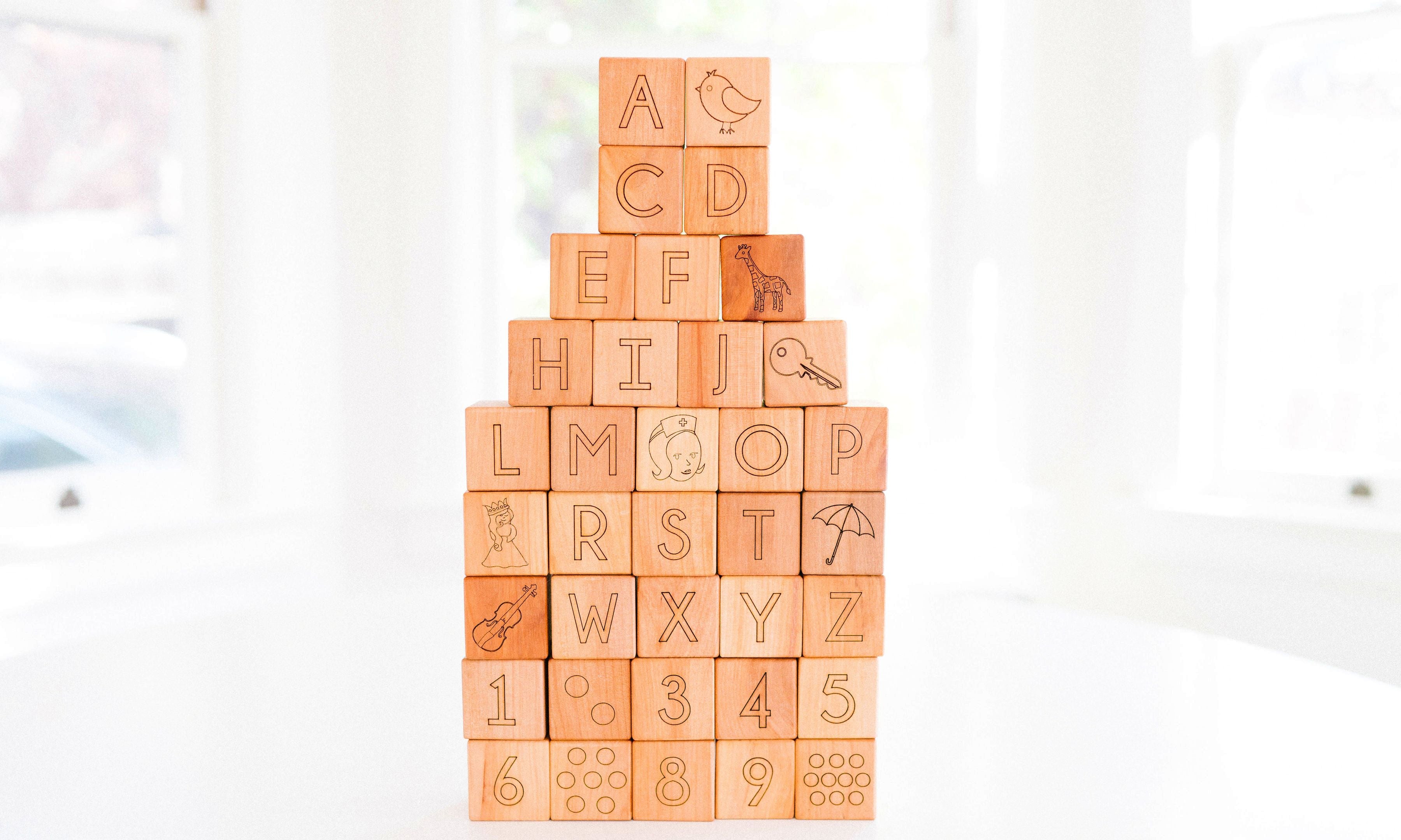 Stack of wooden blocks with letters and numbers on a white background