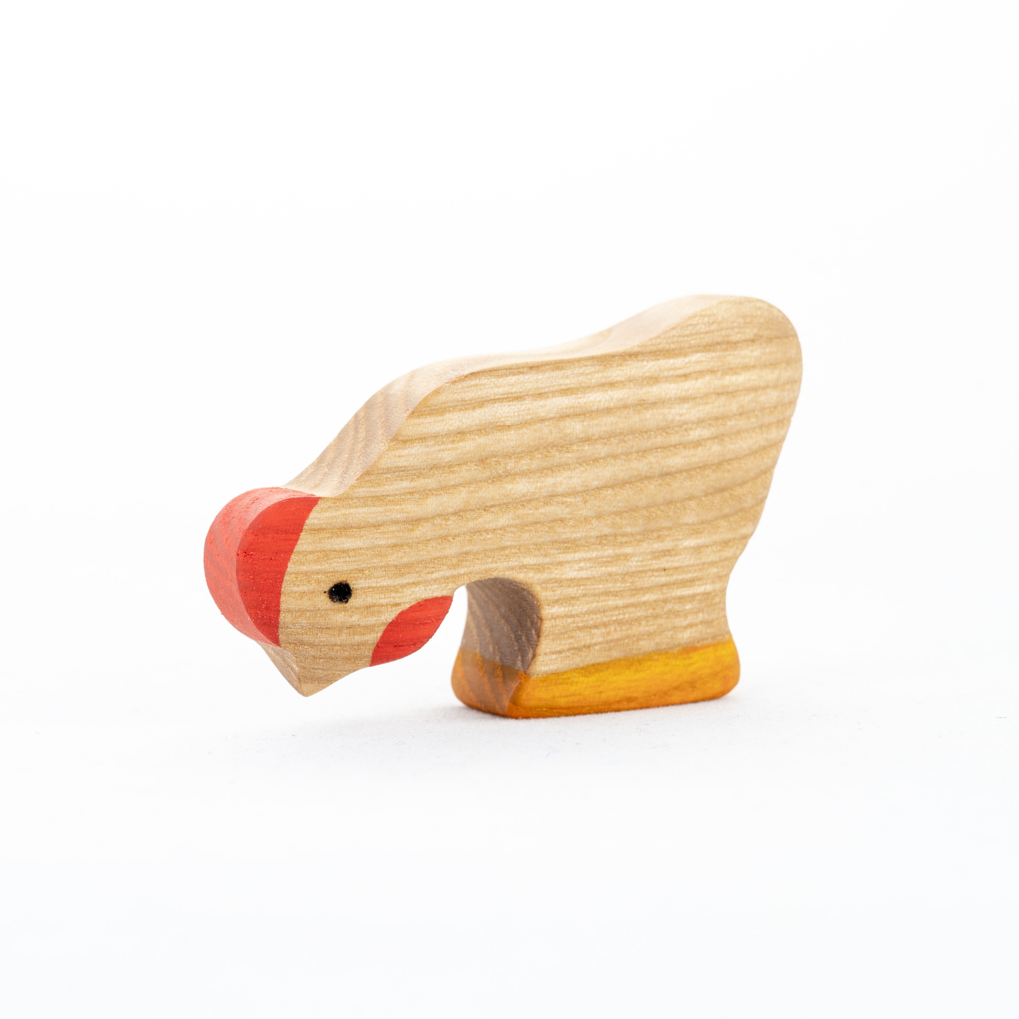 Wooden bear toy with red nose on a white background