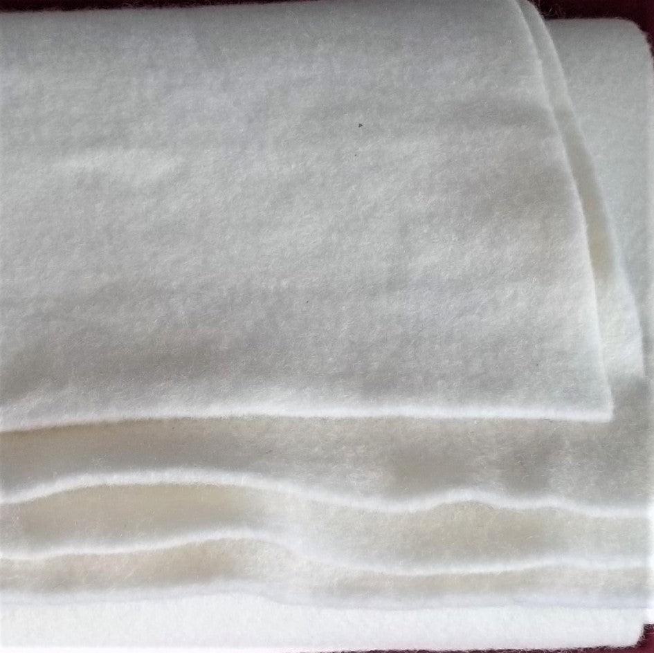Close-up of white fabric with a subtle pattern on a plain background