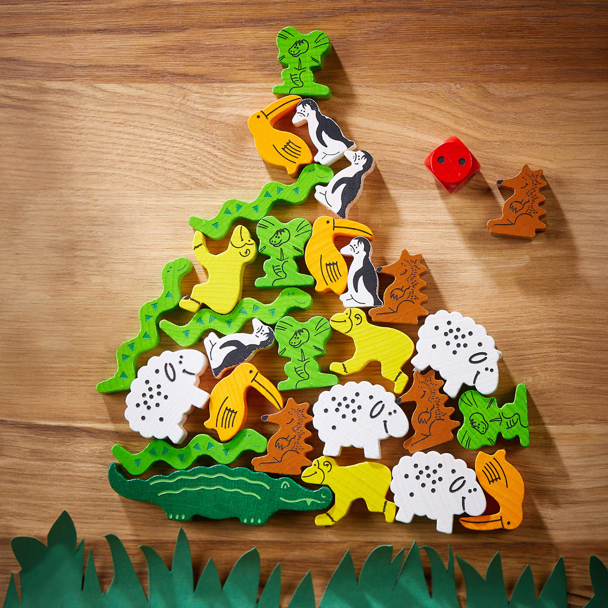 Wooden animal puzzle shaped like a pyramid on a wooden surface