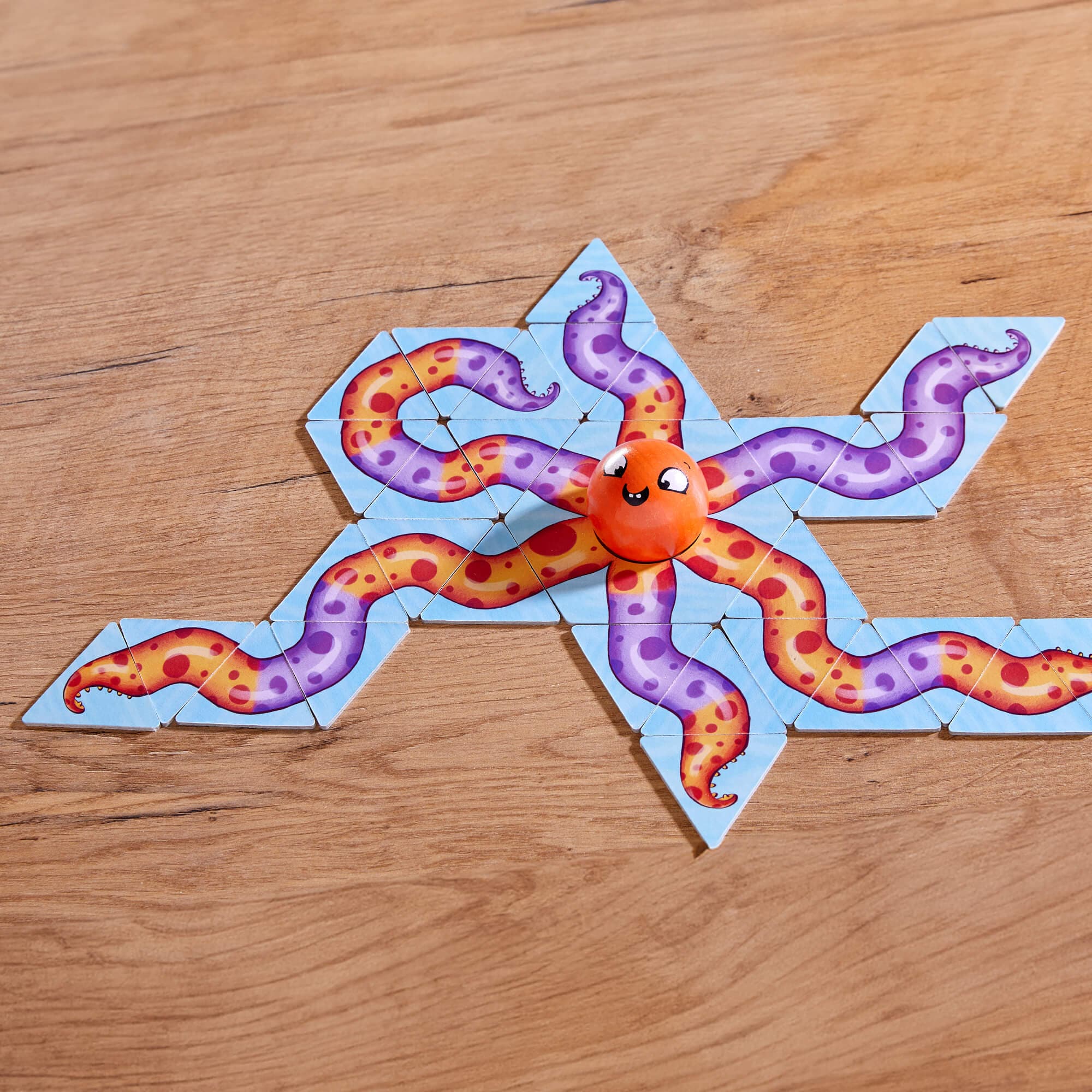 Children's toy with a cartoon octopus on a wooden surface