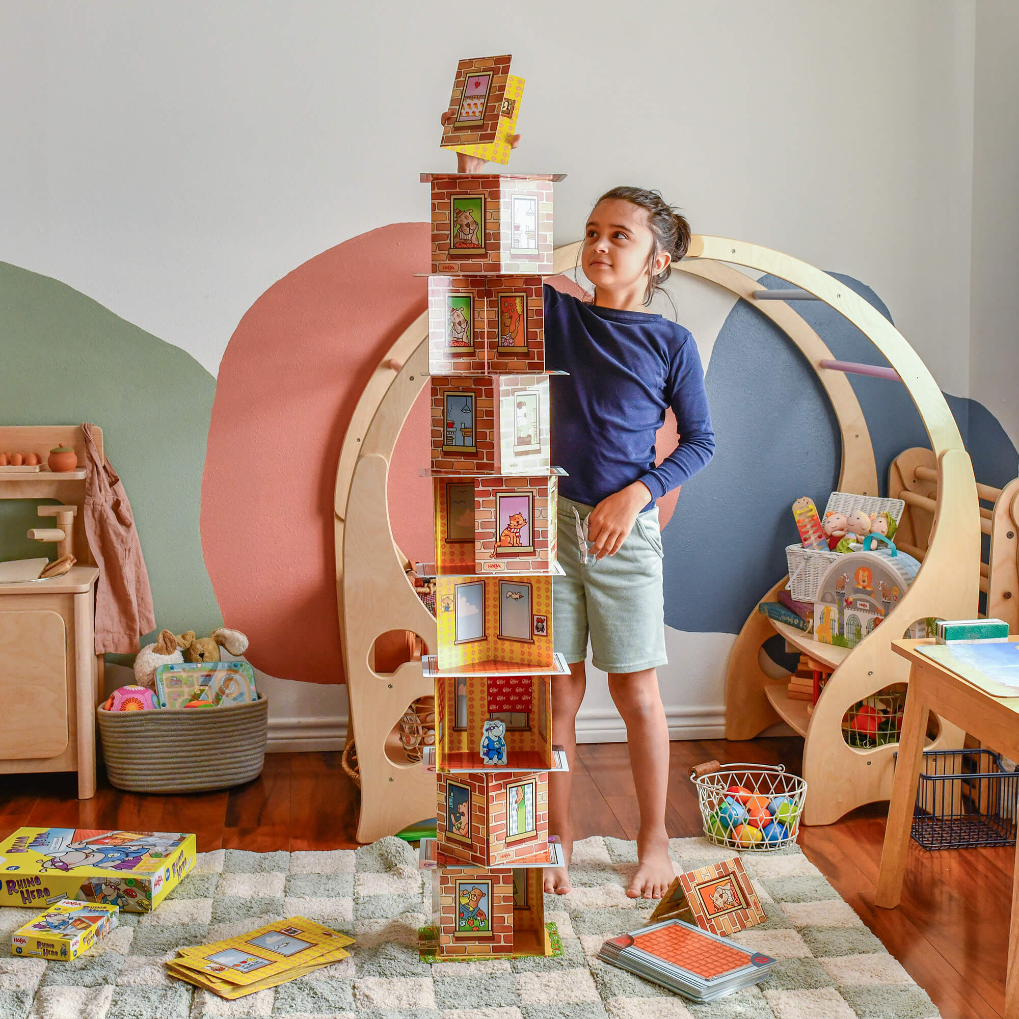 Child playing with a toy bookshelf in a colorful playroom