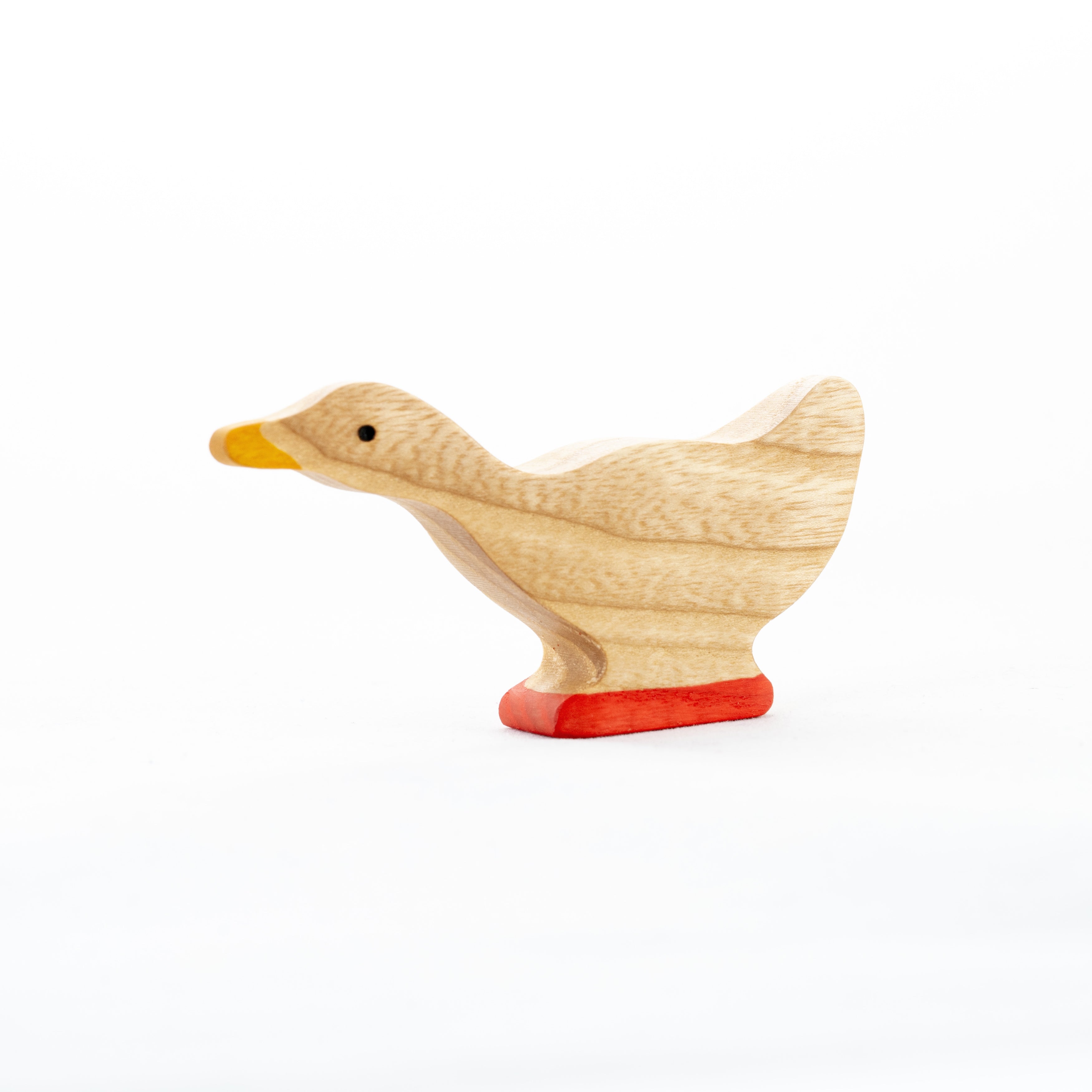 Wooden duck toy with a red base on a white background