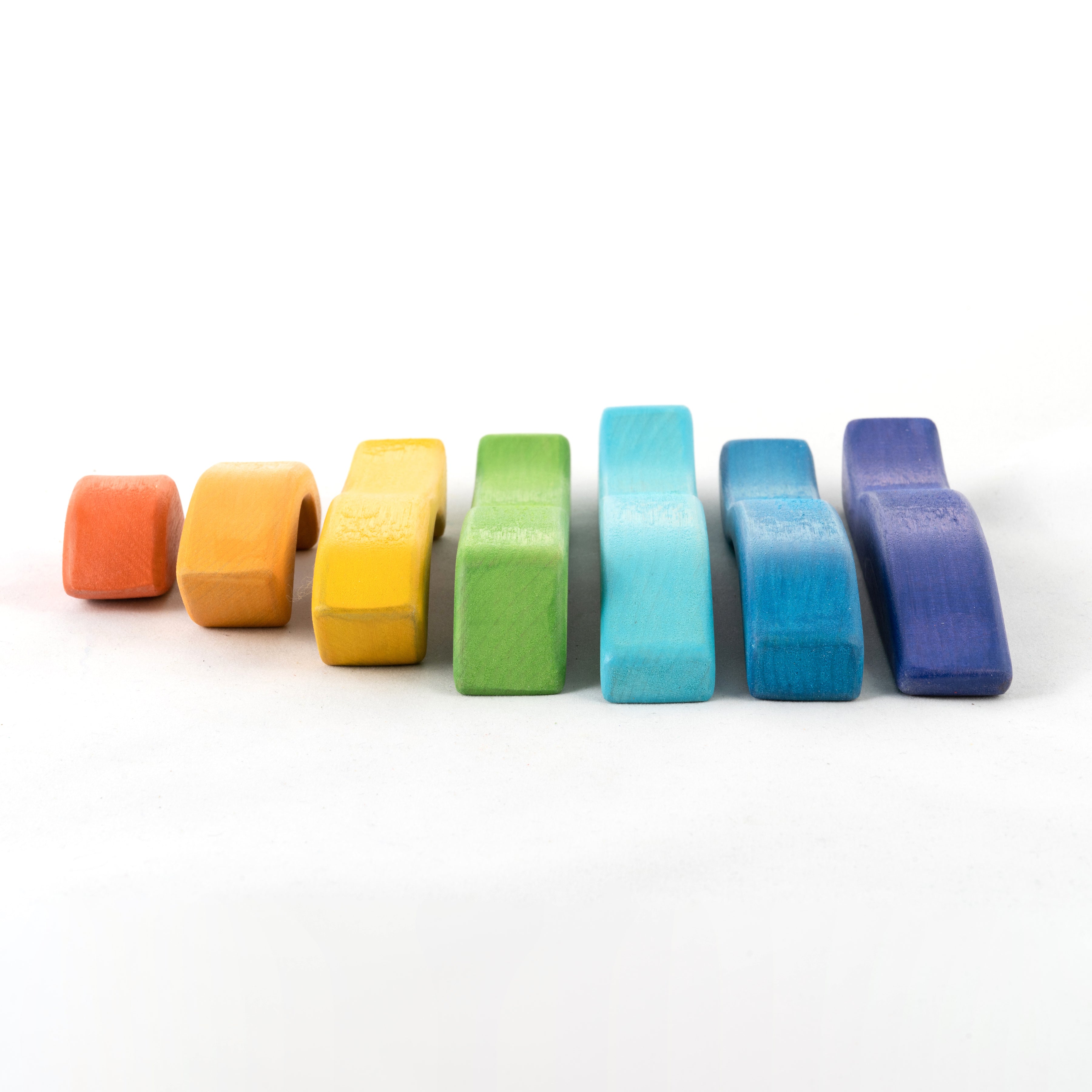 Set of rainbow-colored rubber bands on a white background