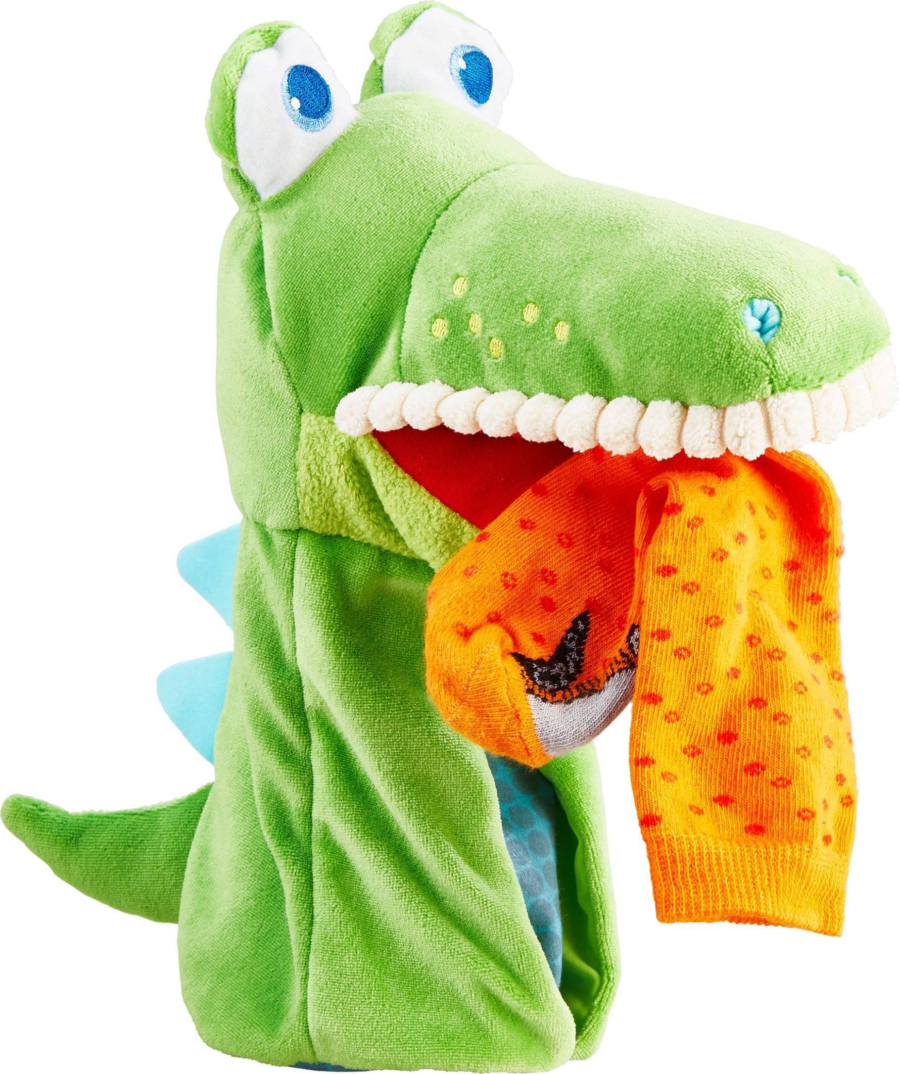 Green dinosaur puppet with an open mouth showing teeth and an orange interior.