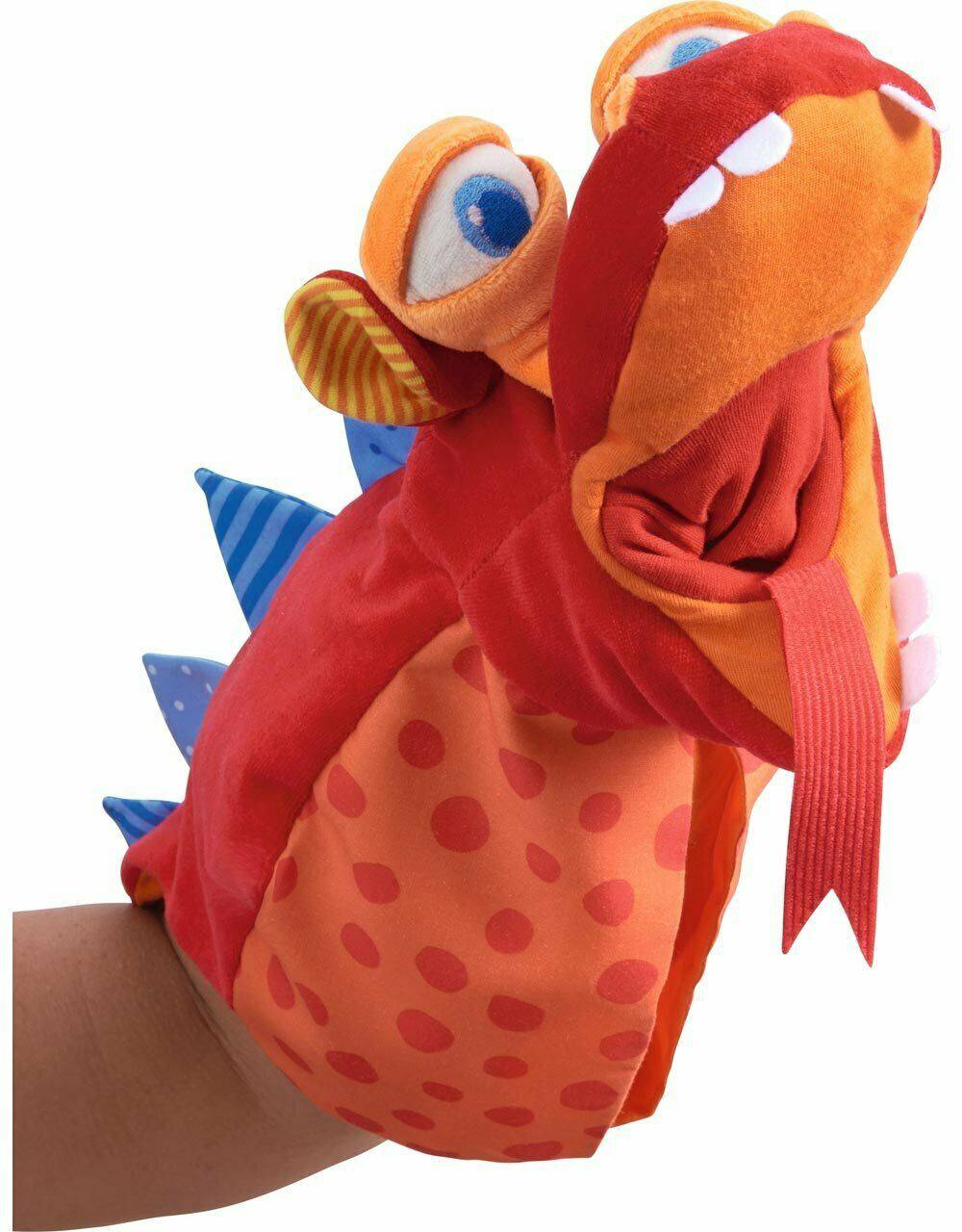 Colorful fish-shaped glove puppet on a hand against a white background
