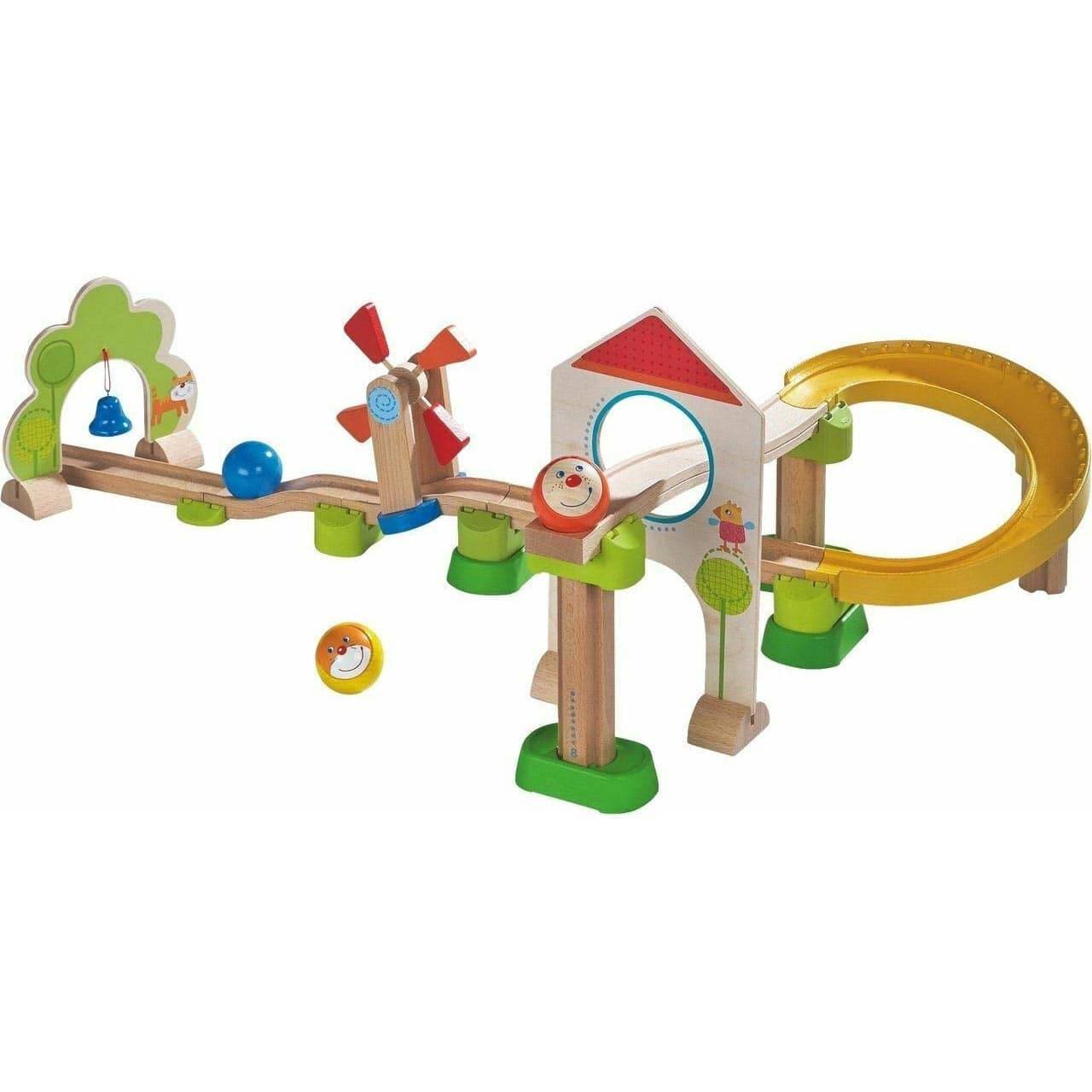 Colorful wooden toy track with various elements on a white background