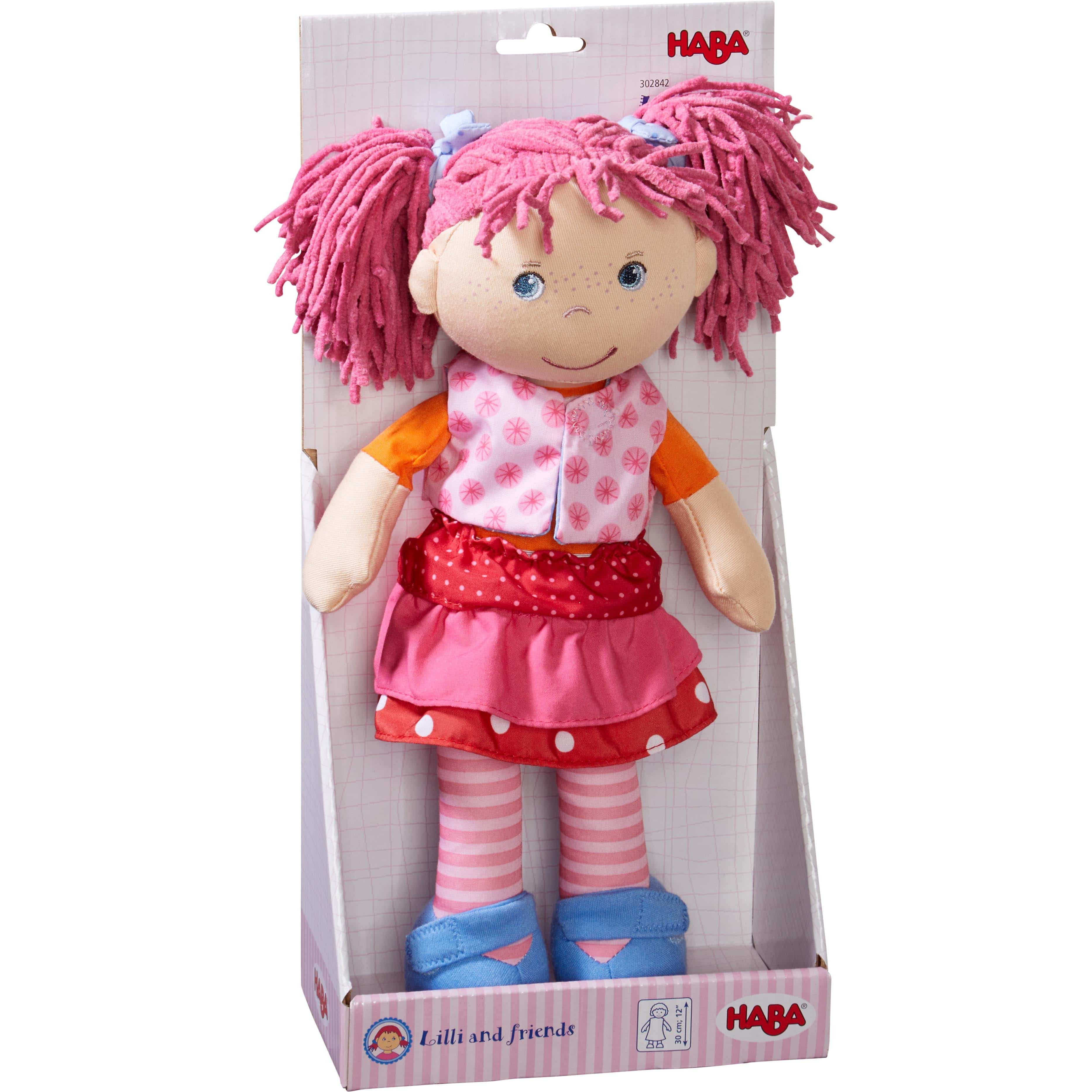 Plush doll with pink hair and outfit in HABA packaging