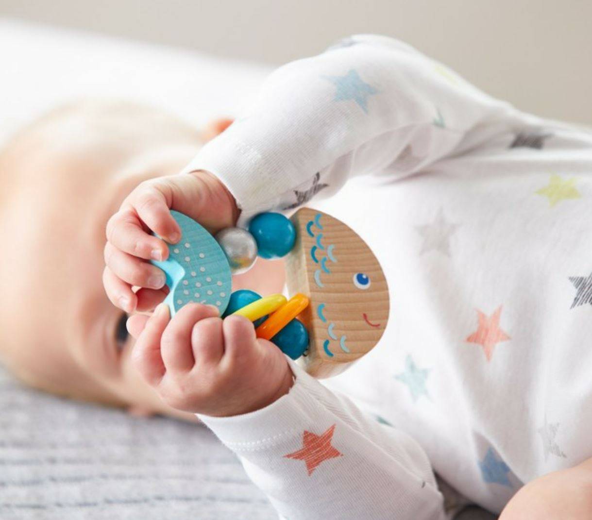 Baby playing with a colorful teething ring