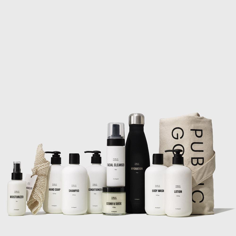 Collection of skincare and haircare products with a tote bag on a white background