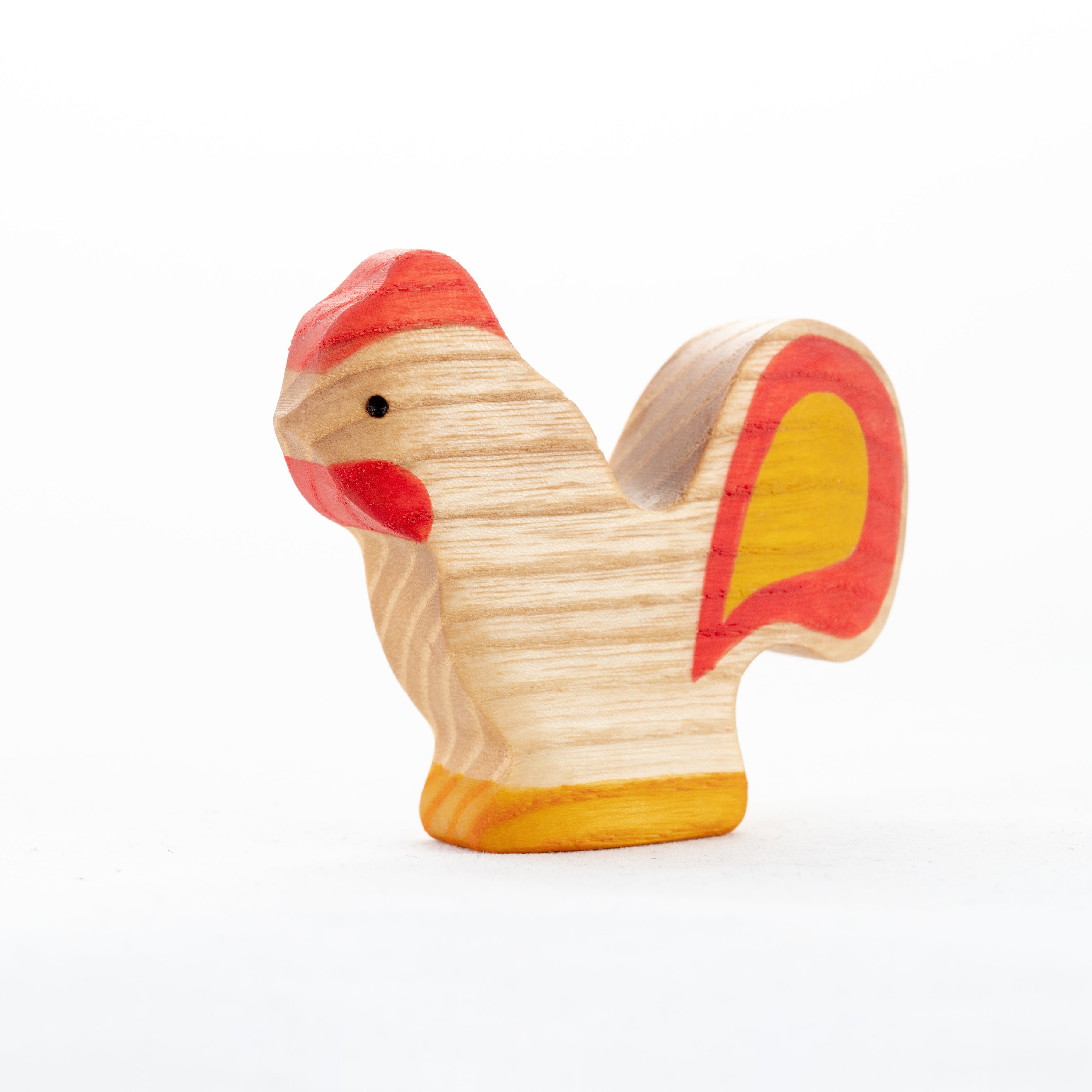 Wooden toy chicken with red comb and wattles on a white background