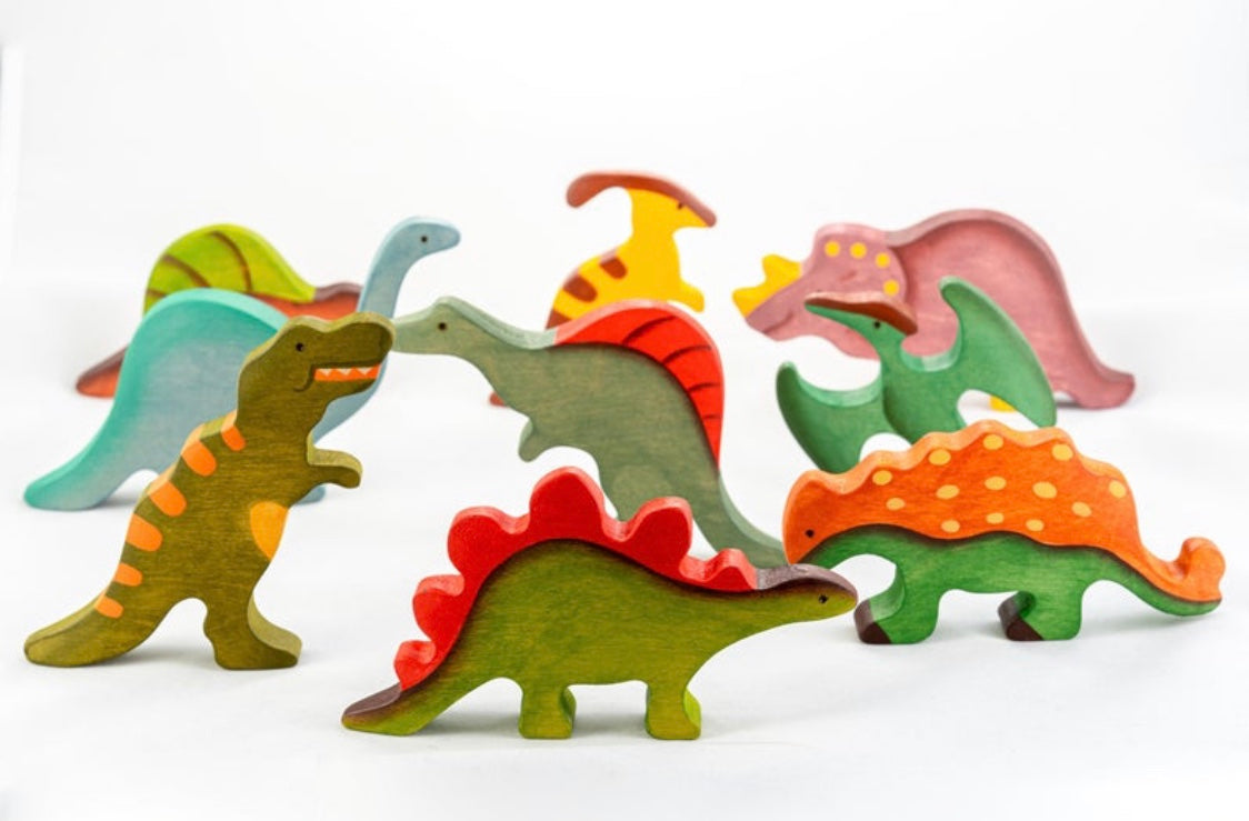 Colorful wooden dinosaur toys on a white background