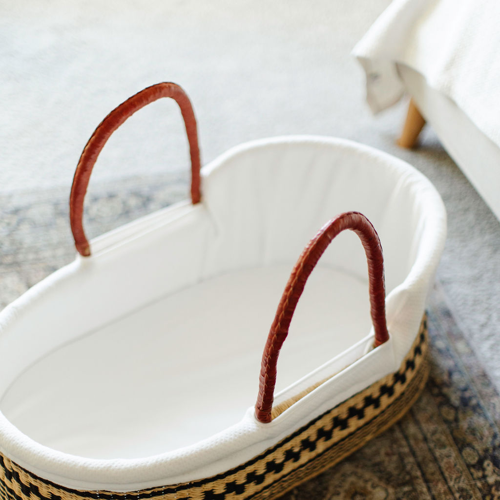 White ceramic planter with brown handles on a textured surface