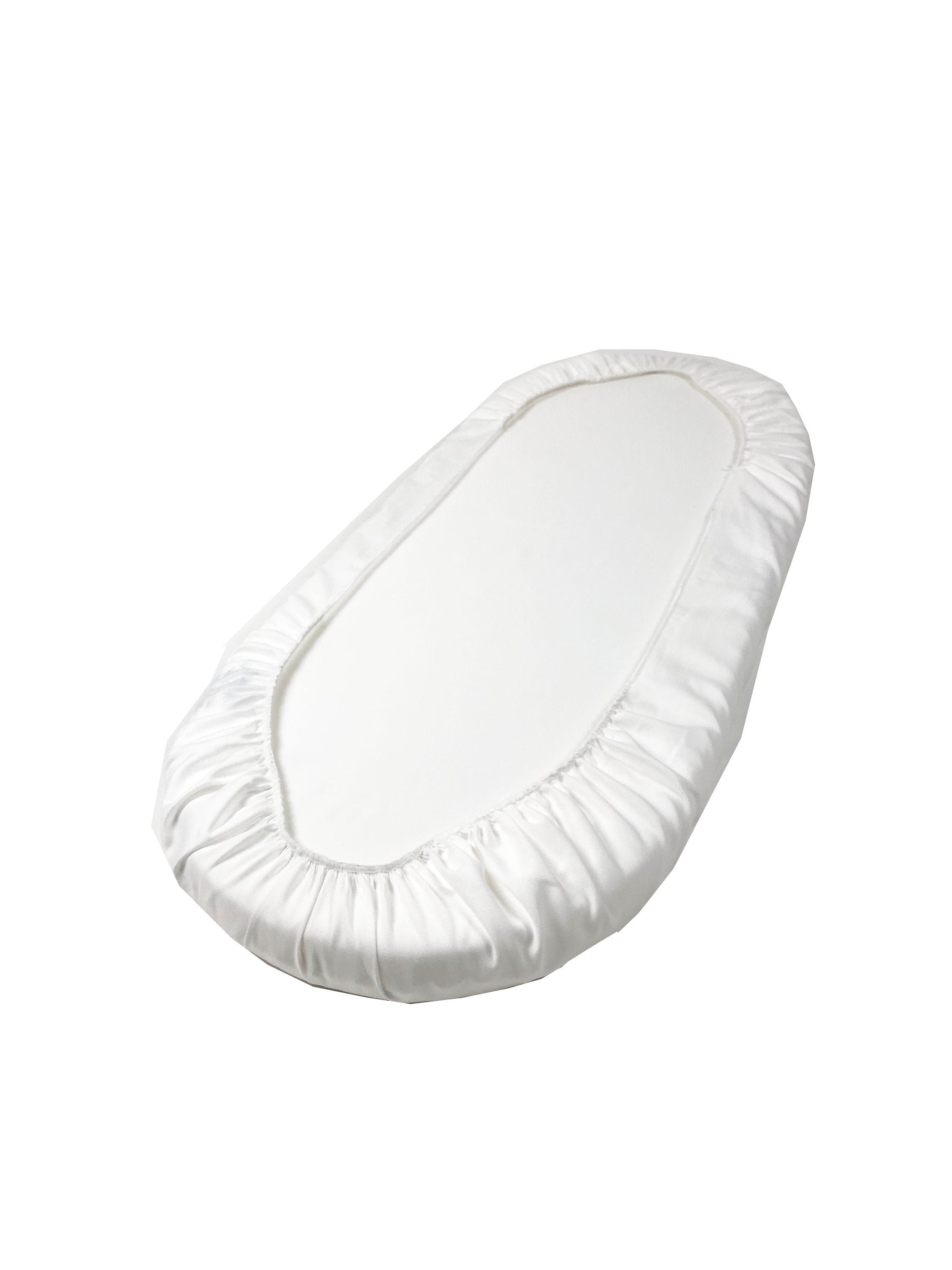 White fitted sheet on a mattress against a white background