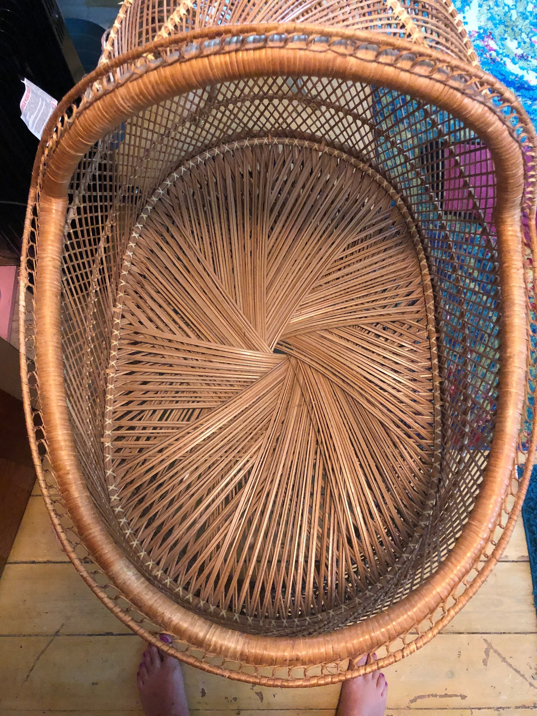 Woven basket with a circular pattern on a wooden floor