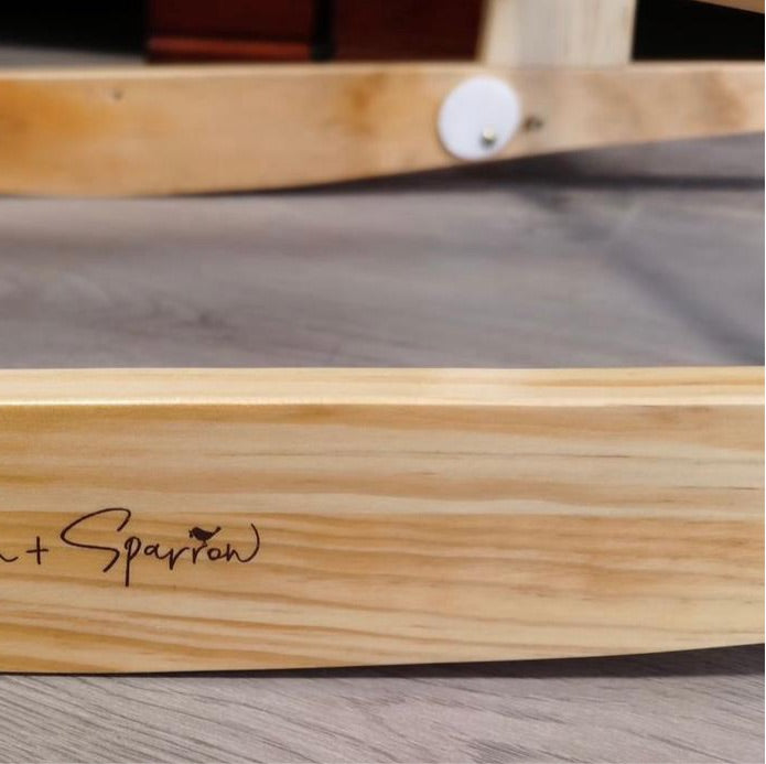 Wooden product with 'Sparrow' branding on a gray surface