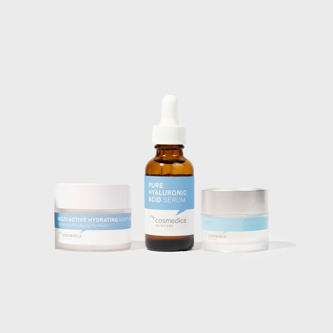 Cosmetic products including a dropper bottle and two jars on a light gray background