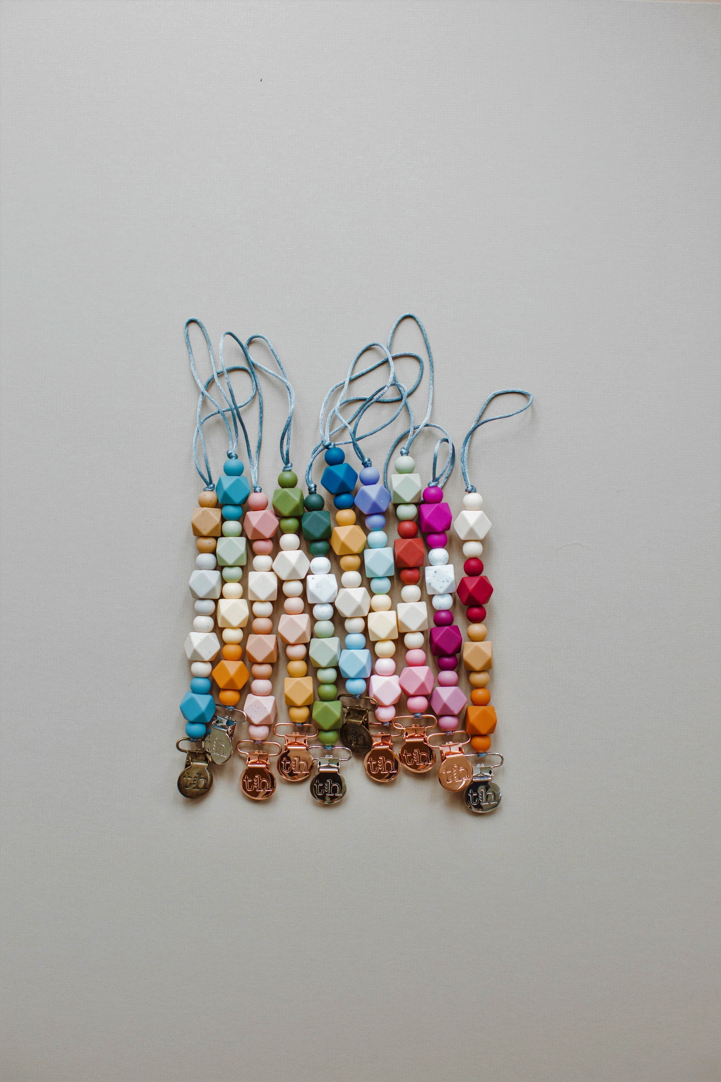 Colorful beaded keychains on a light gray background