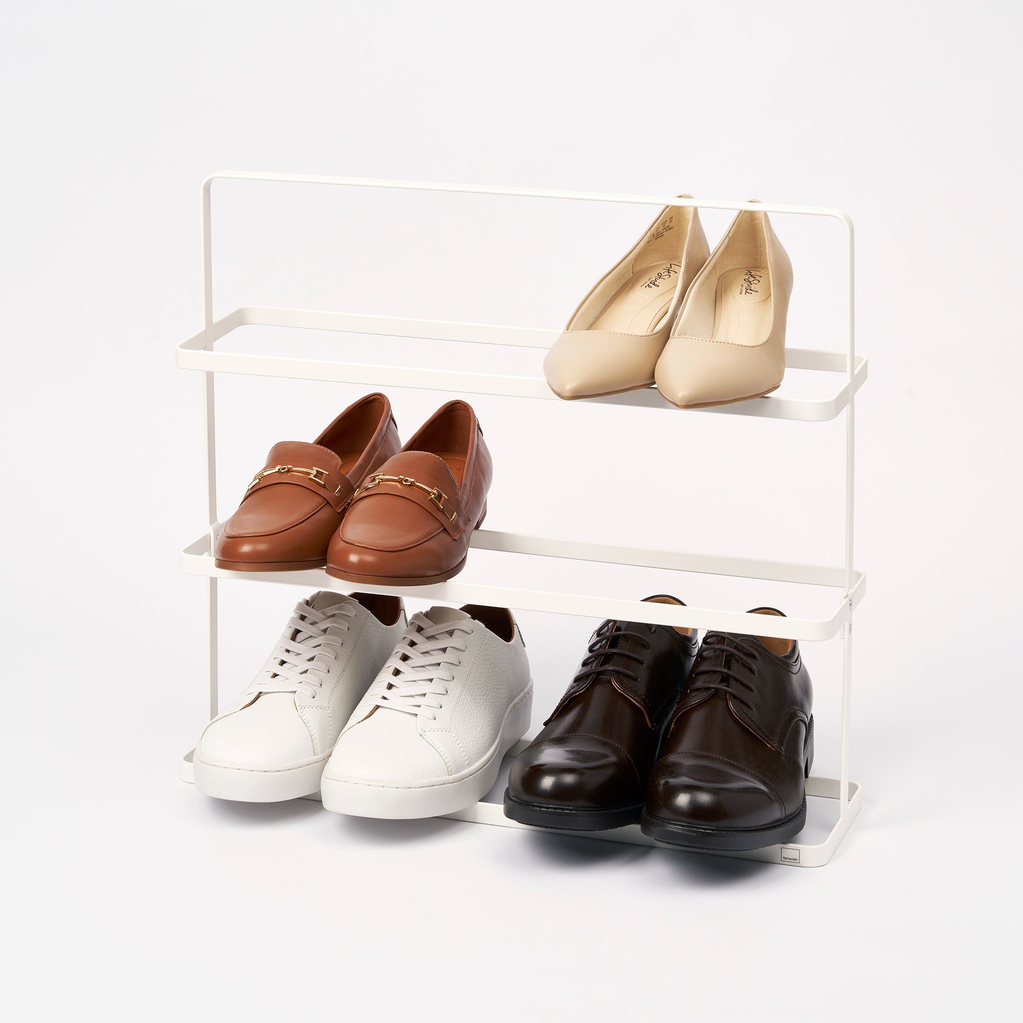 Shoe rack with various shoes on a white background