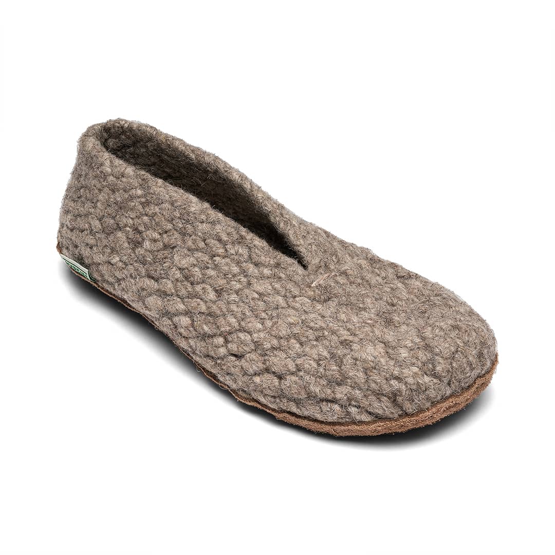 Brown slippers with textured sole on a white background