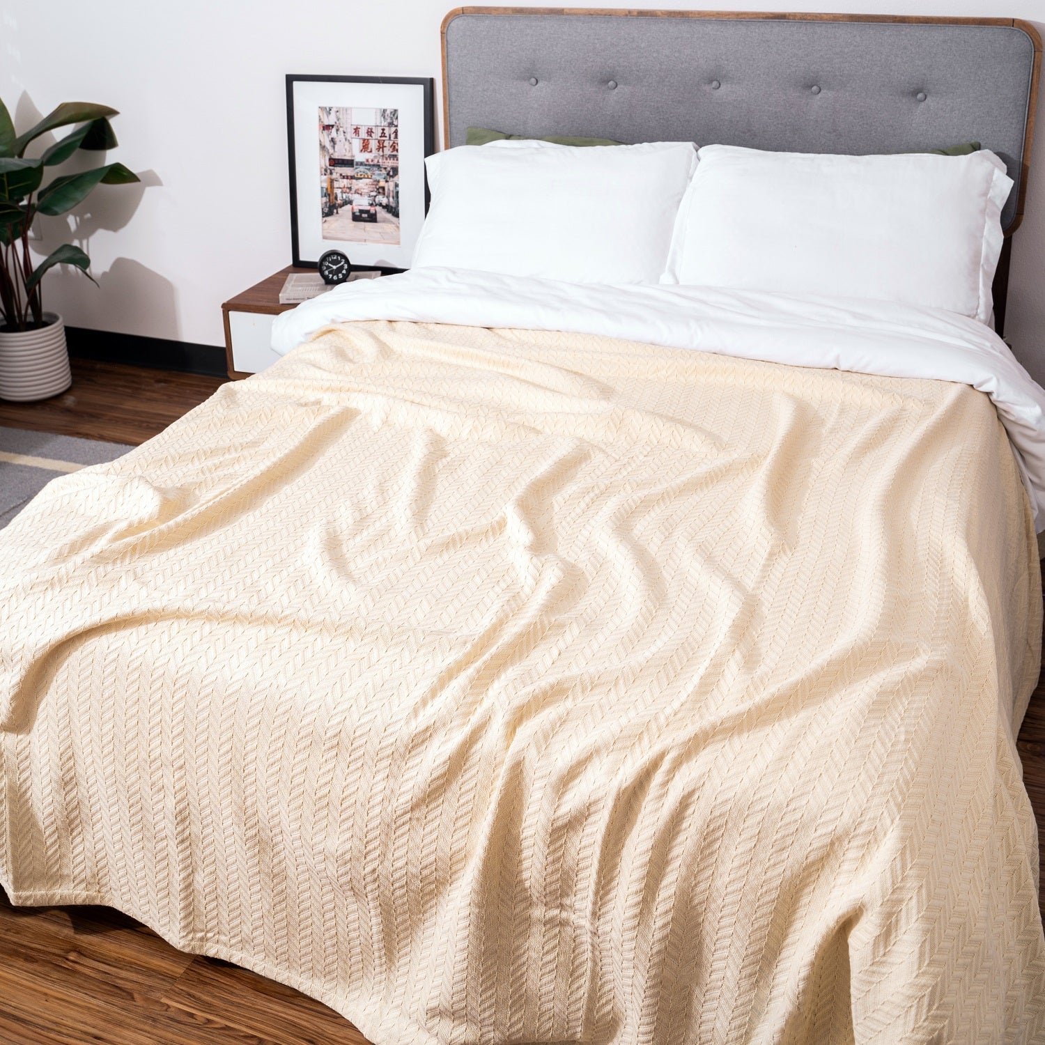 Beige blanket on a bed in a bedroom setting