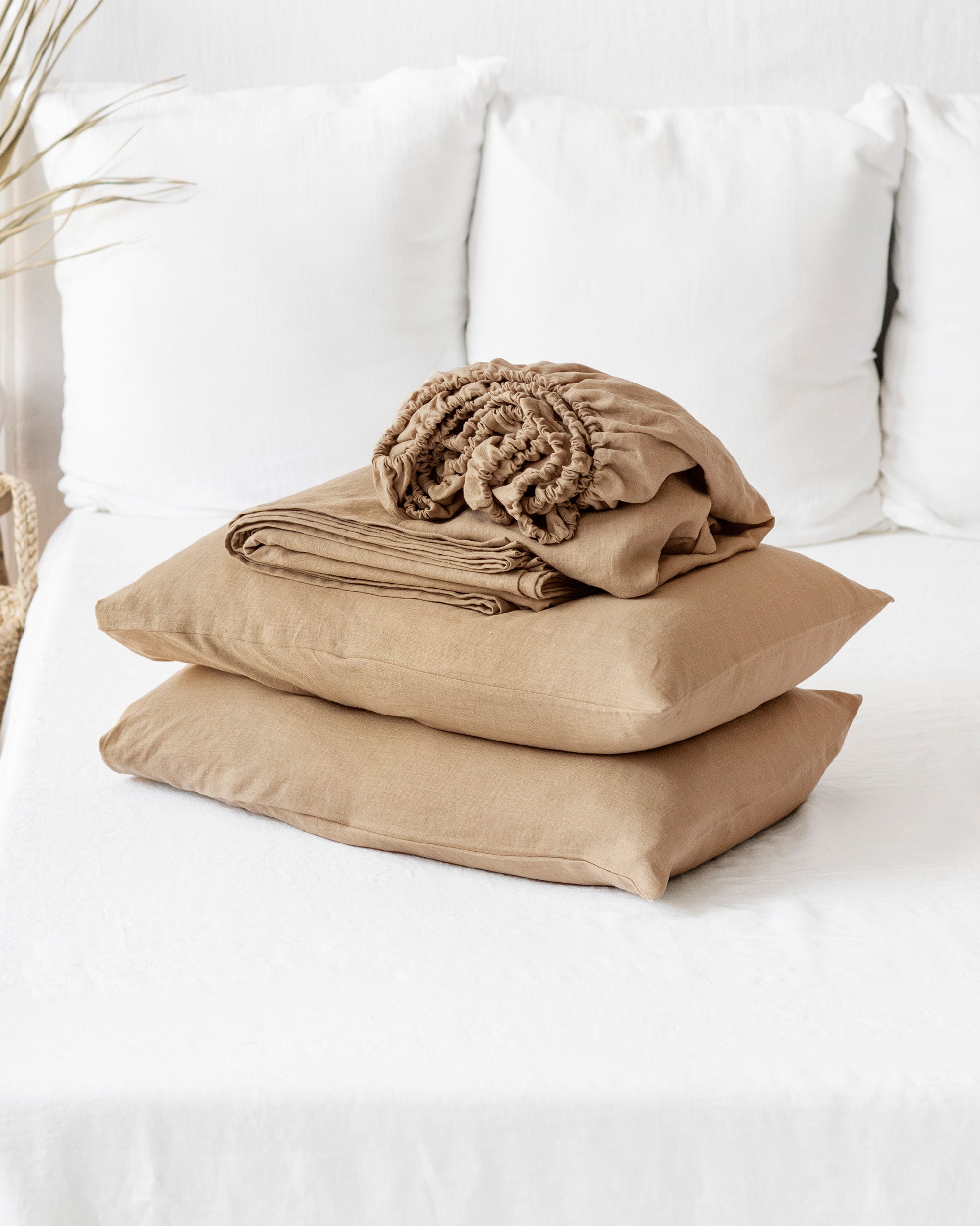Beige pillows and blanket on a white sofa