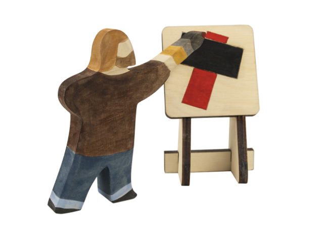 Wooden figure of a person painting on an easel with colorful canvas