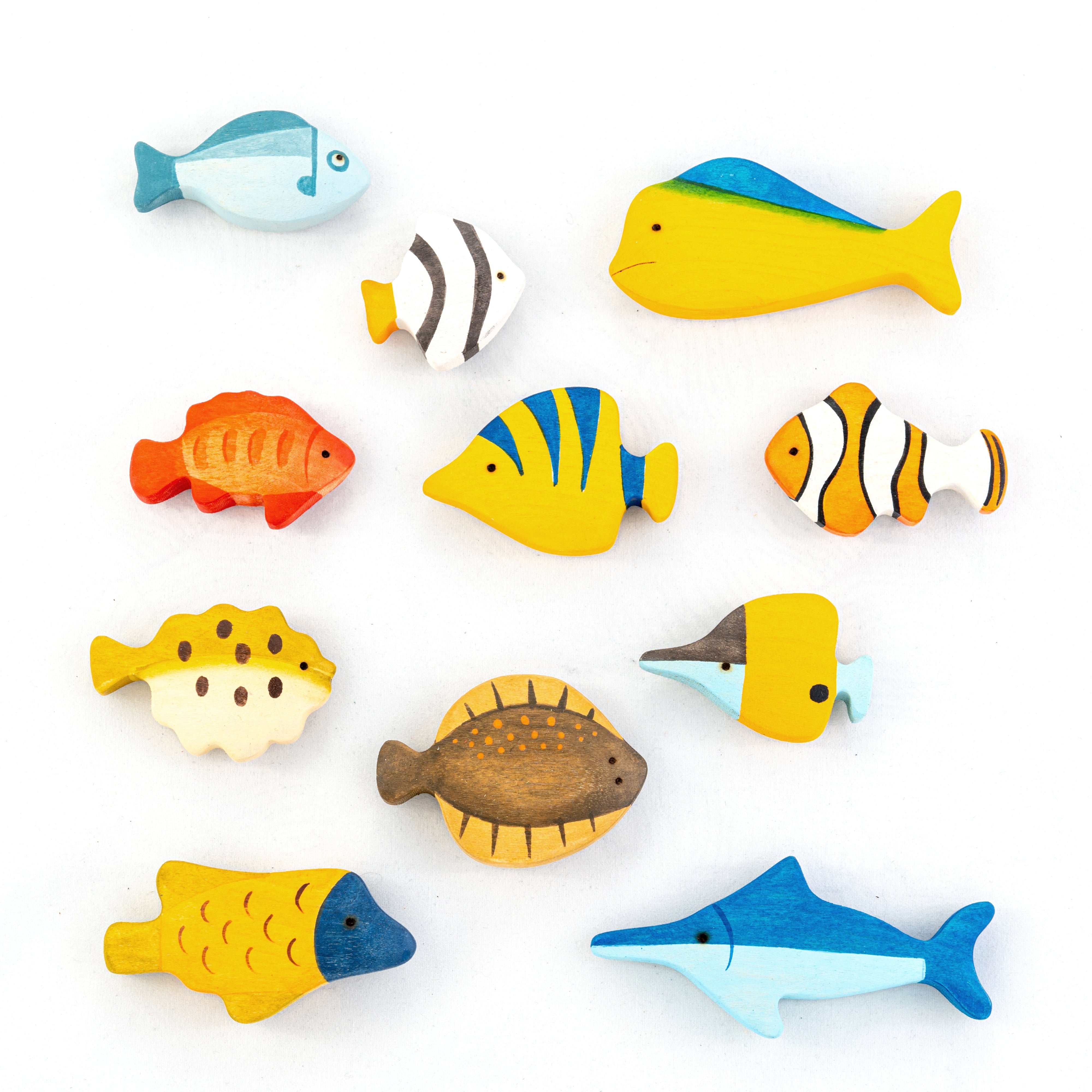Set of colorful wooden fish toys on a white background