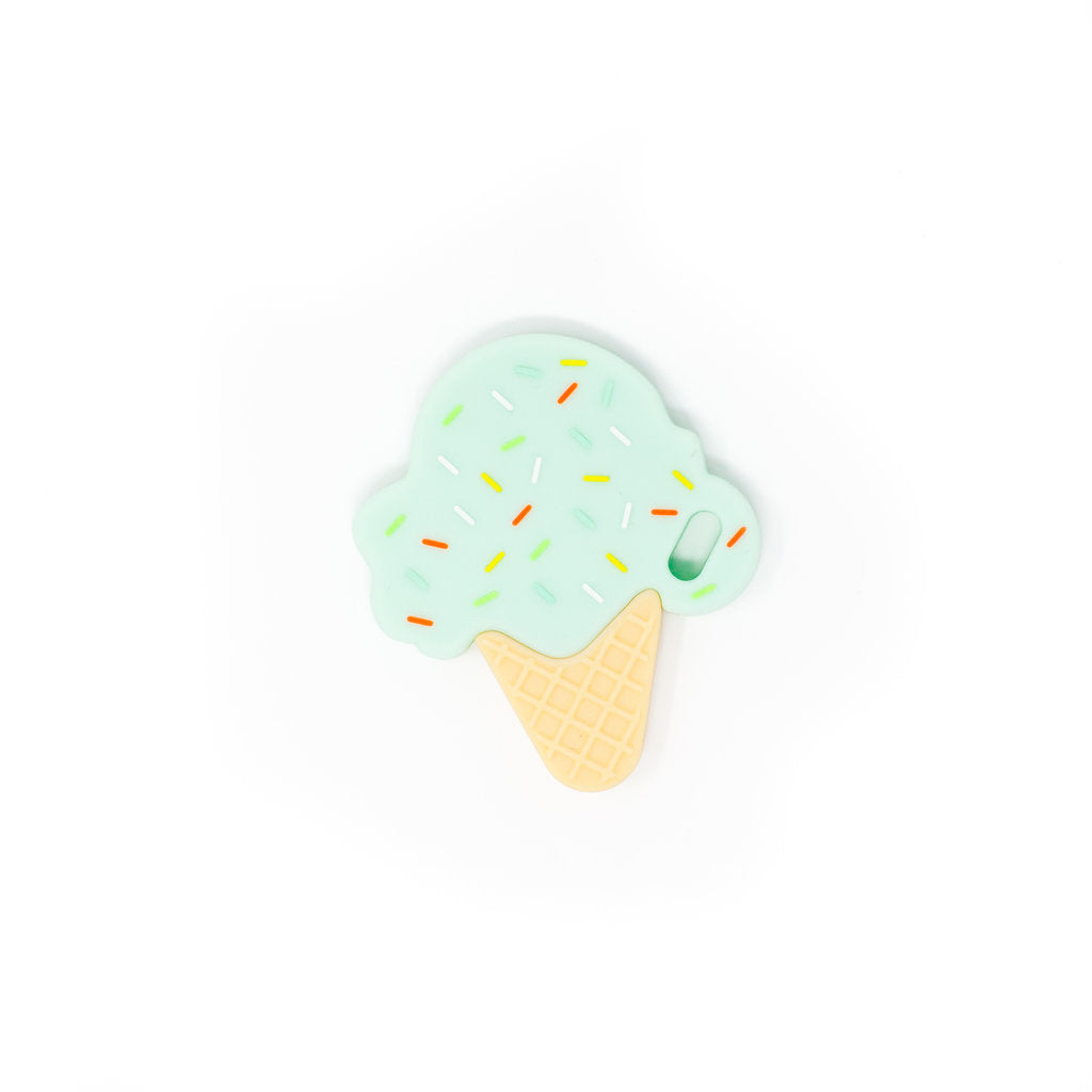 Ice cream cone-shaped object with mint green top and yellow sprinkles on a white background