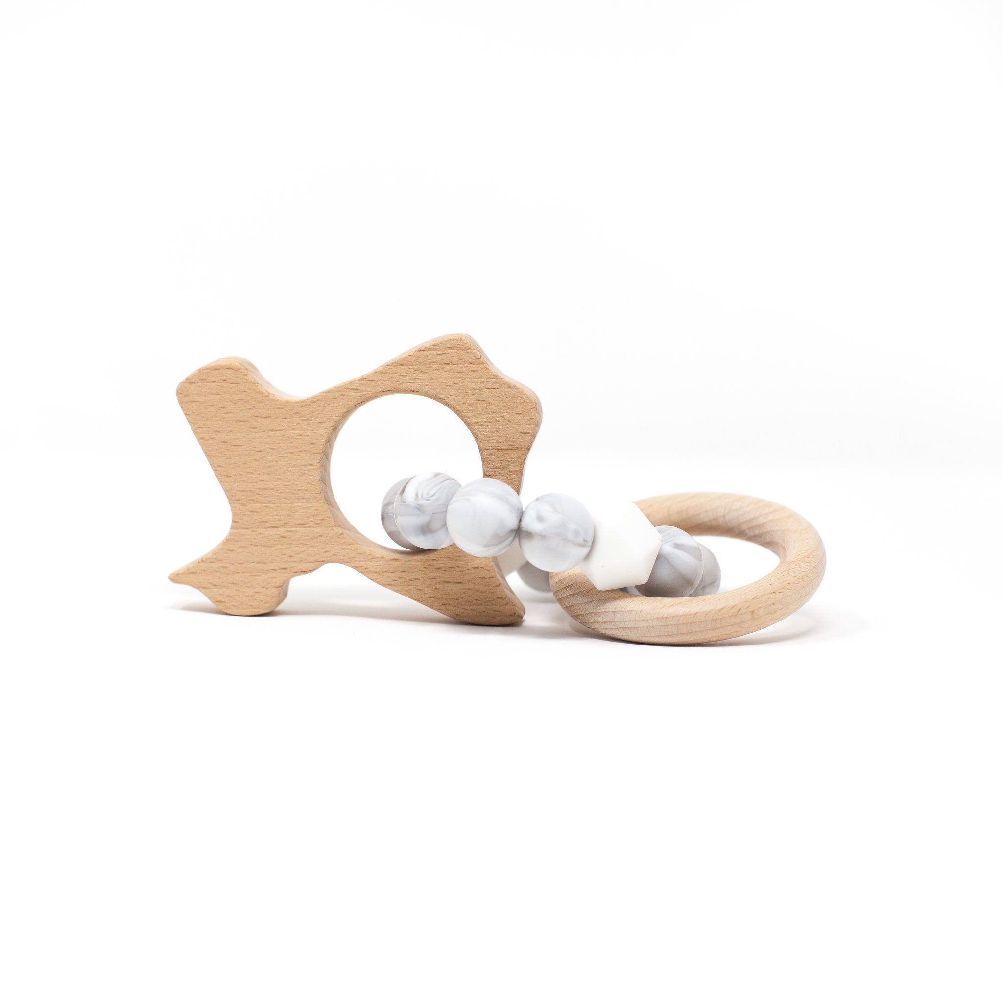Wooden teething ring with star design and marble beads on a white background
