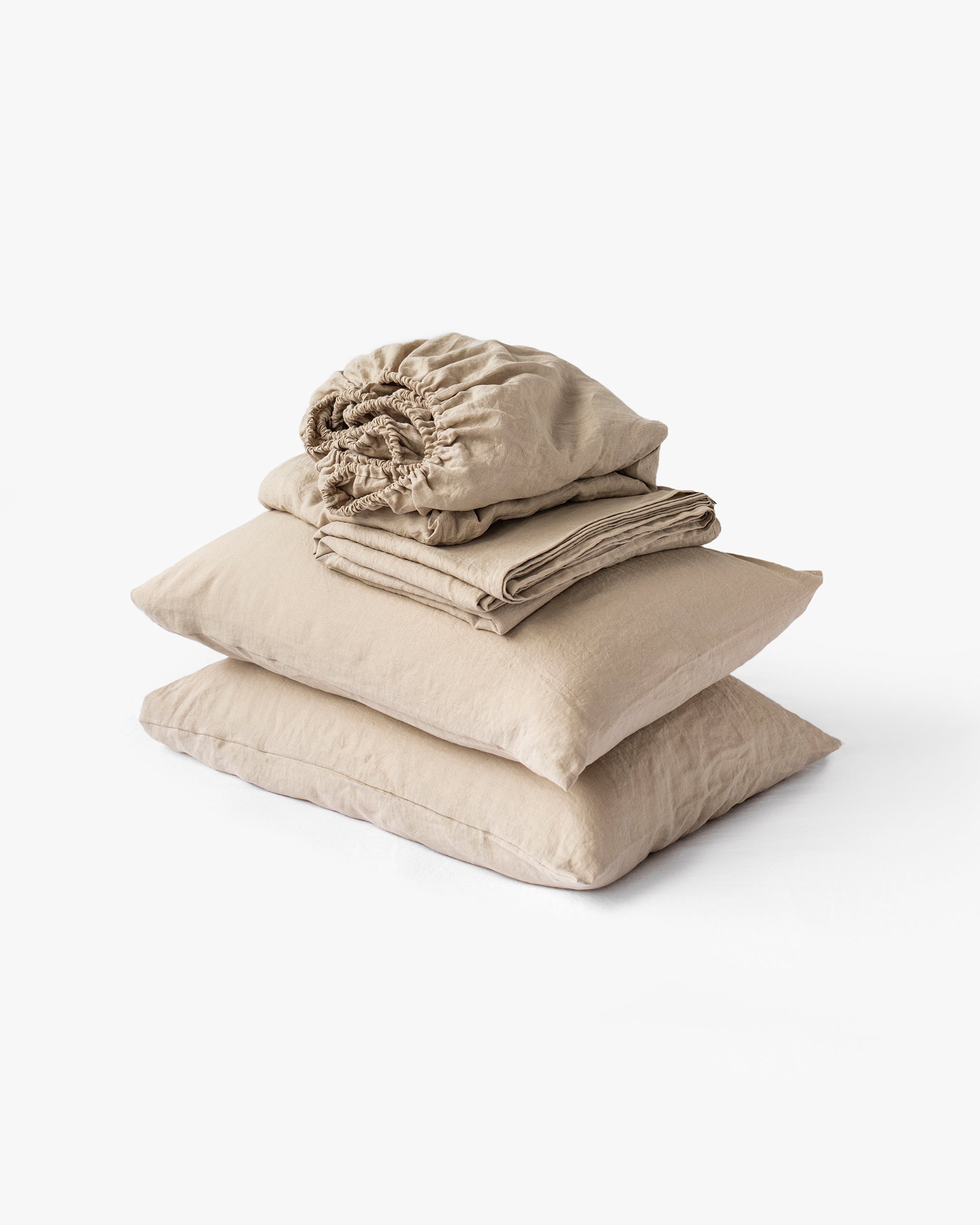 Stack of beige bedding on a white background