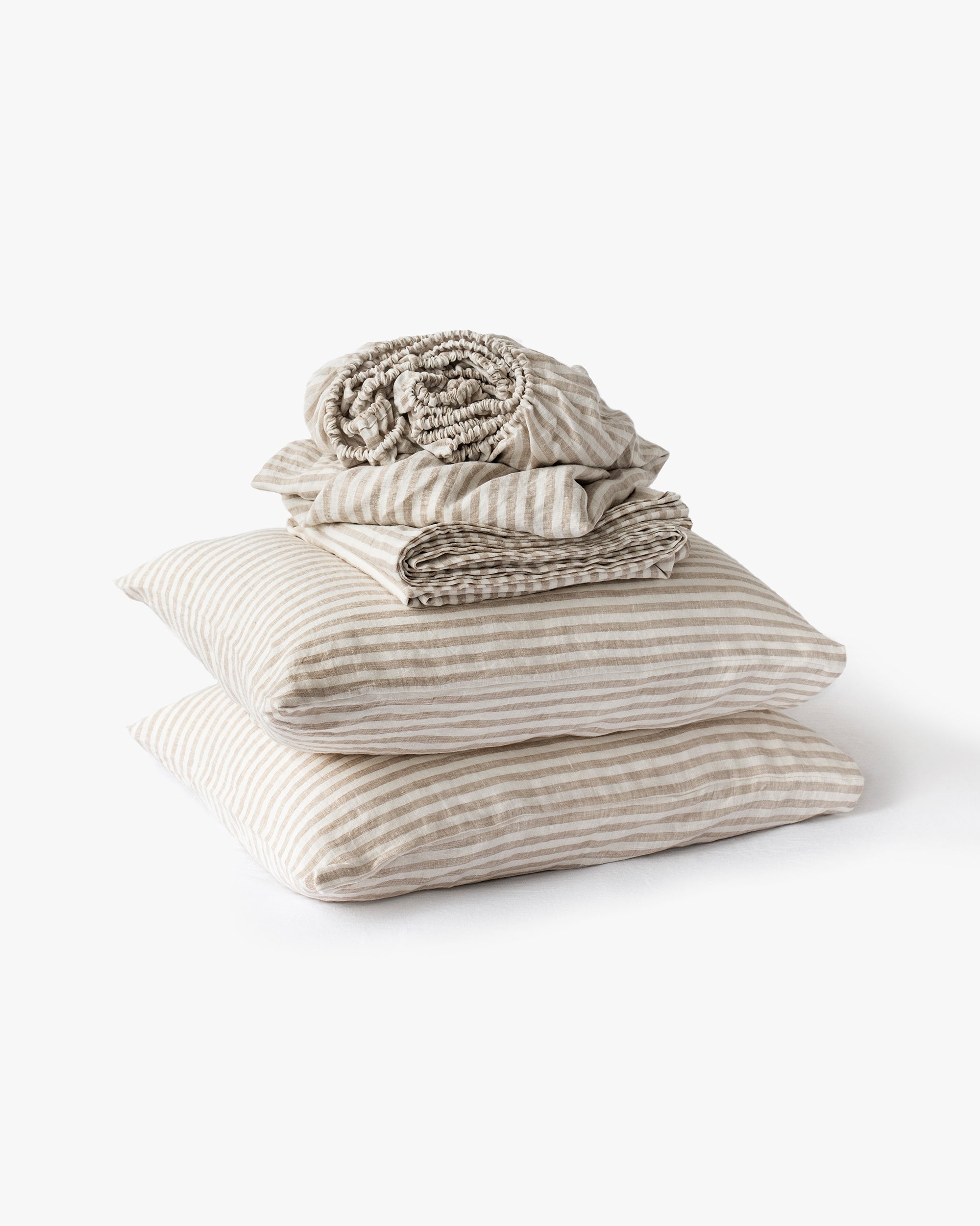 Stack of folded striped bedding on a white background