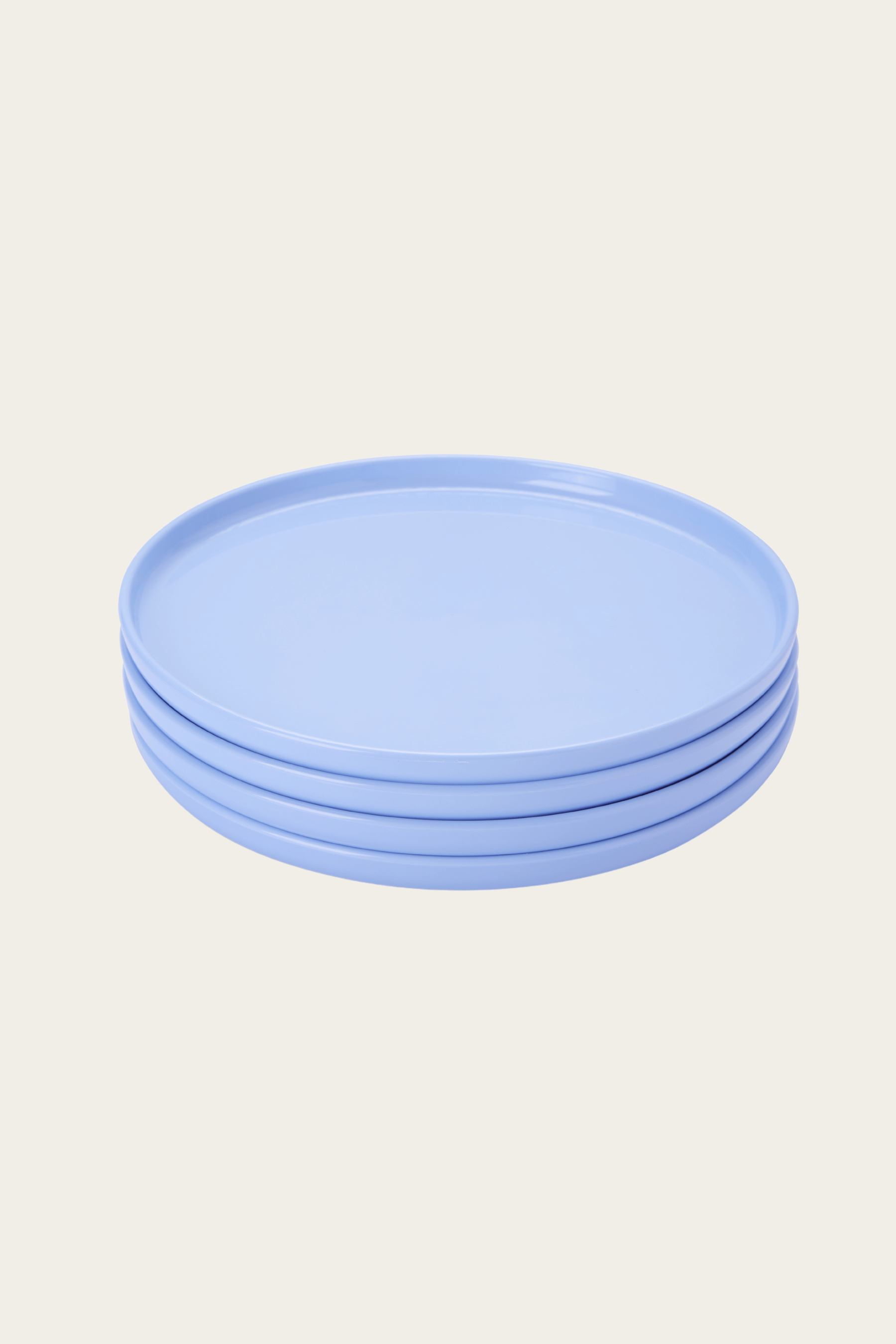 Stack of light blue plates on a beige background