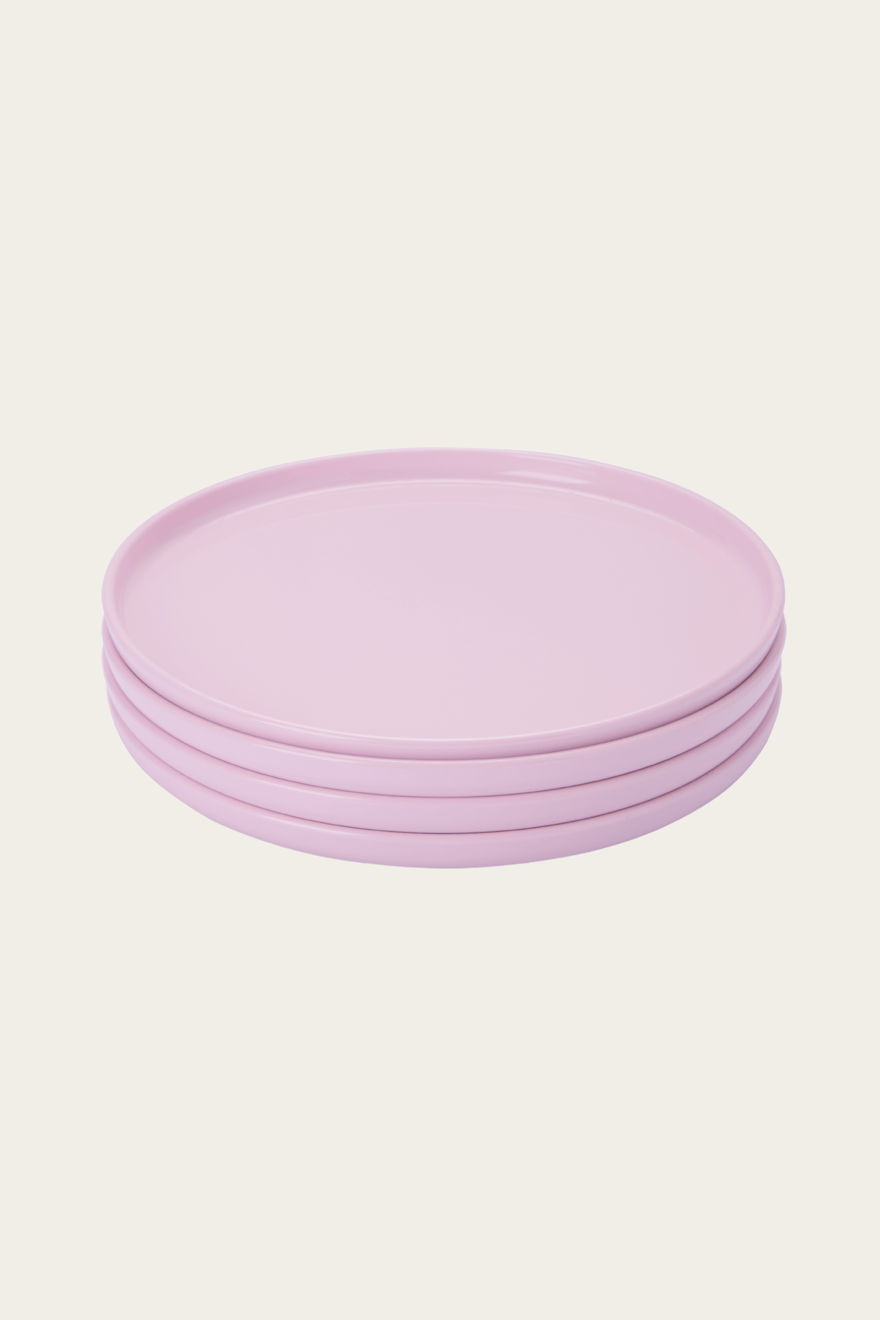 Stack of purple plates on a light pink background