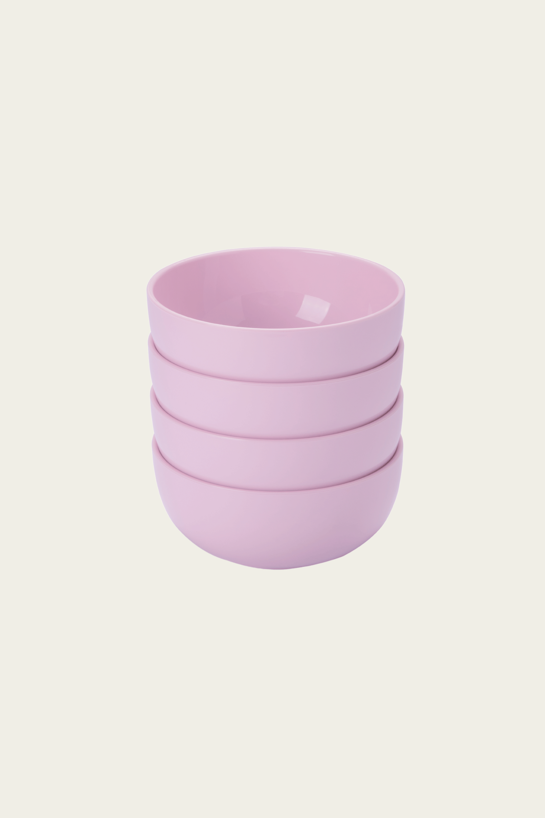 Stack of four pink bowls on a light pink background