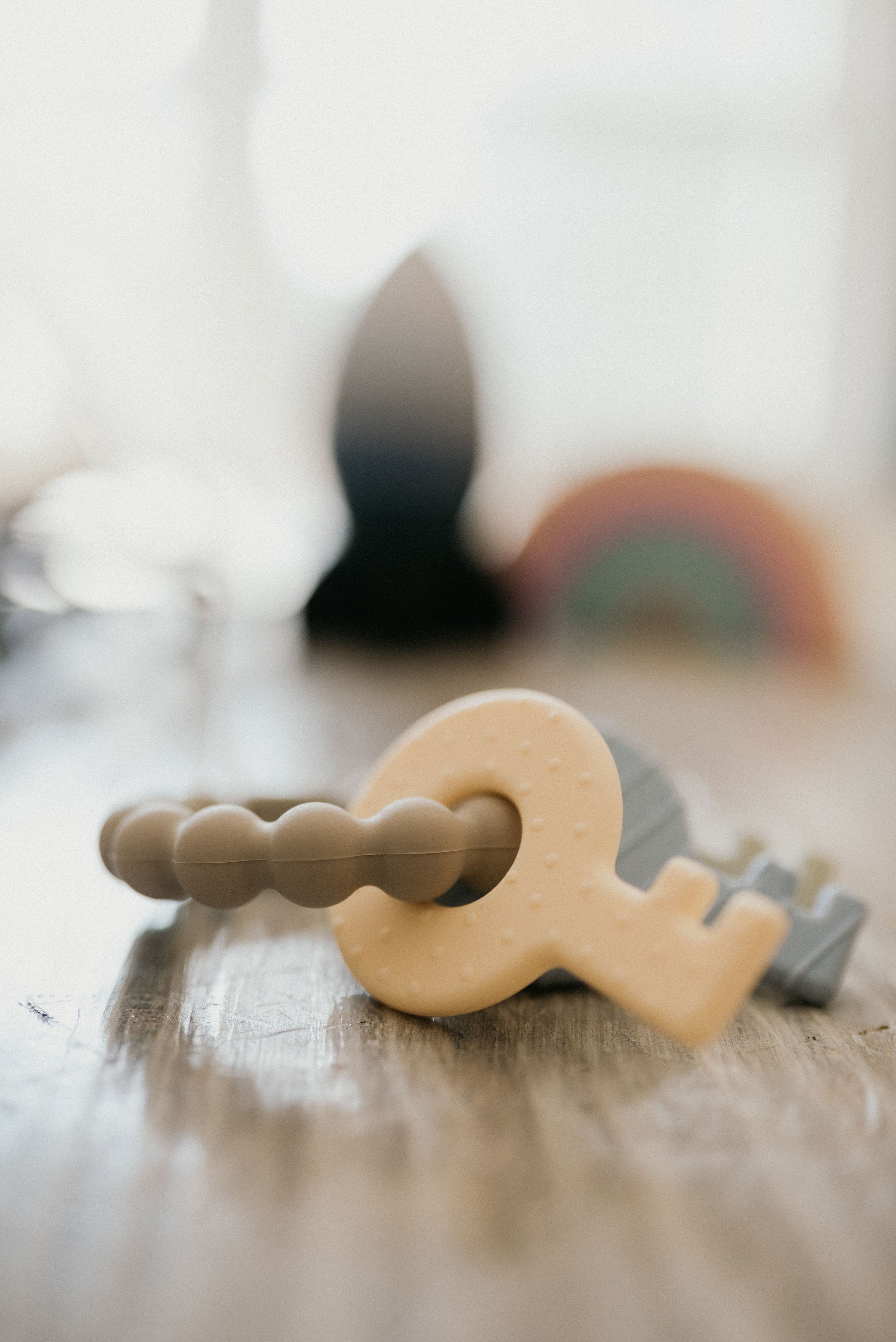 Teething toy with a key design on a wooden surface