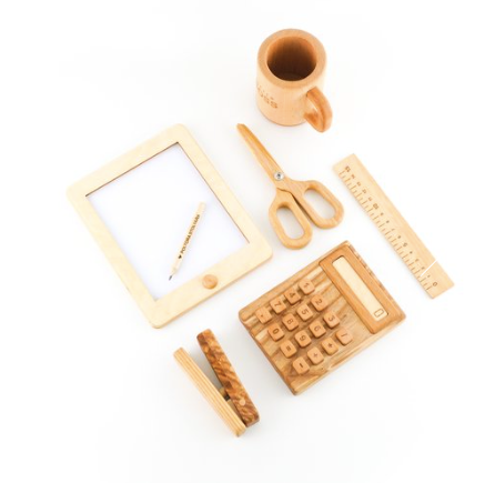 Collection of wooden office supplies including a mug, scissors, ruler, and calculator on a white background