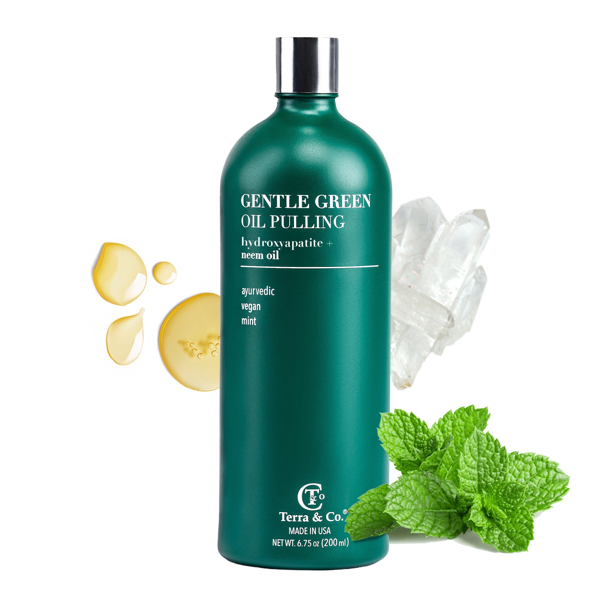 Green bottle of 'Gentle Green Oil Pulling' with oil droplets and mint leaves on a white background