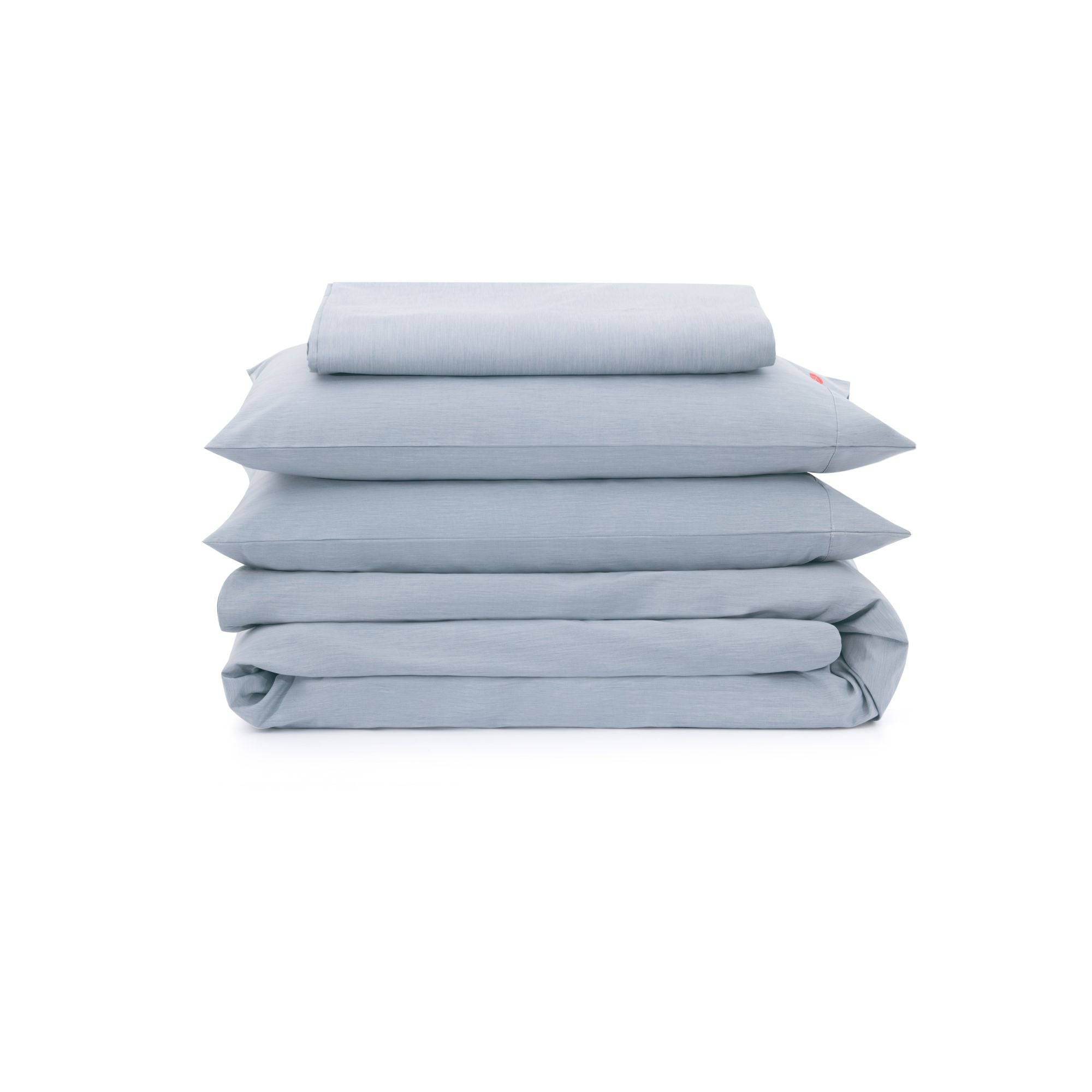 Stack of light blue bedding on a white background