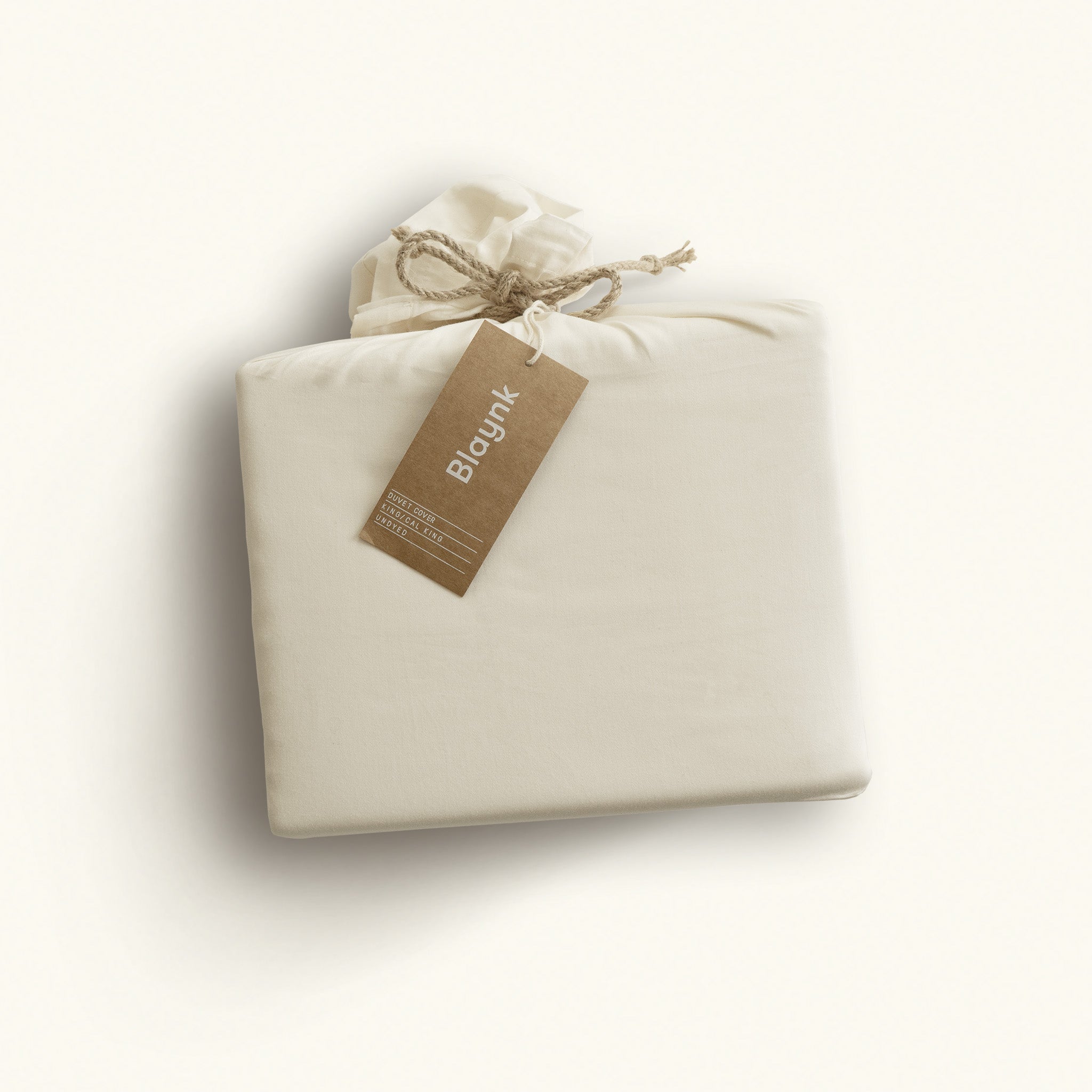 Folded beige fabric with a brown tag on a white background
