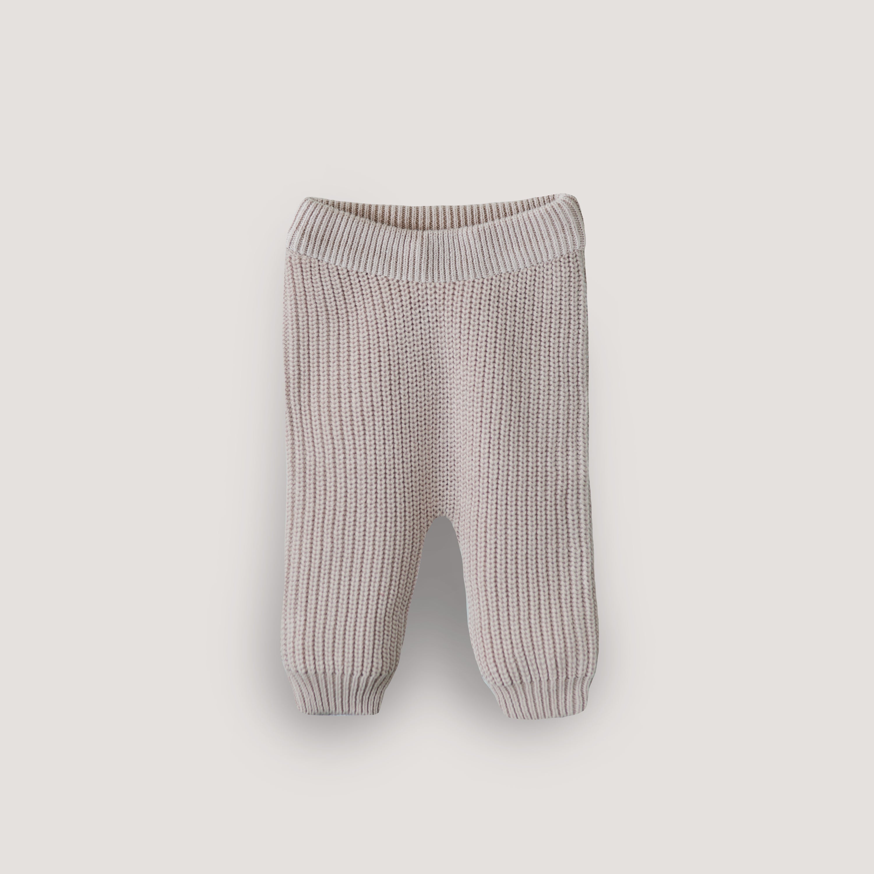 Knitted baby pants on a light gray background