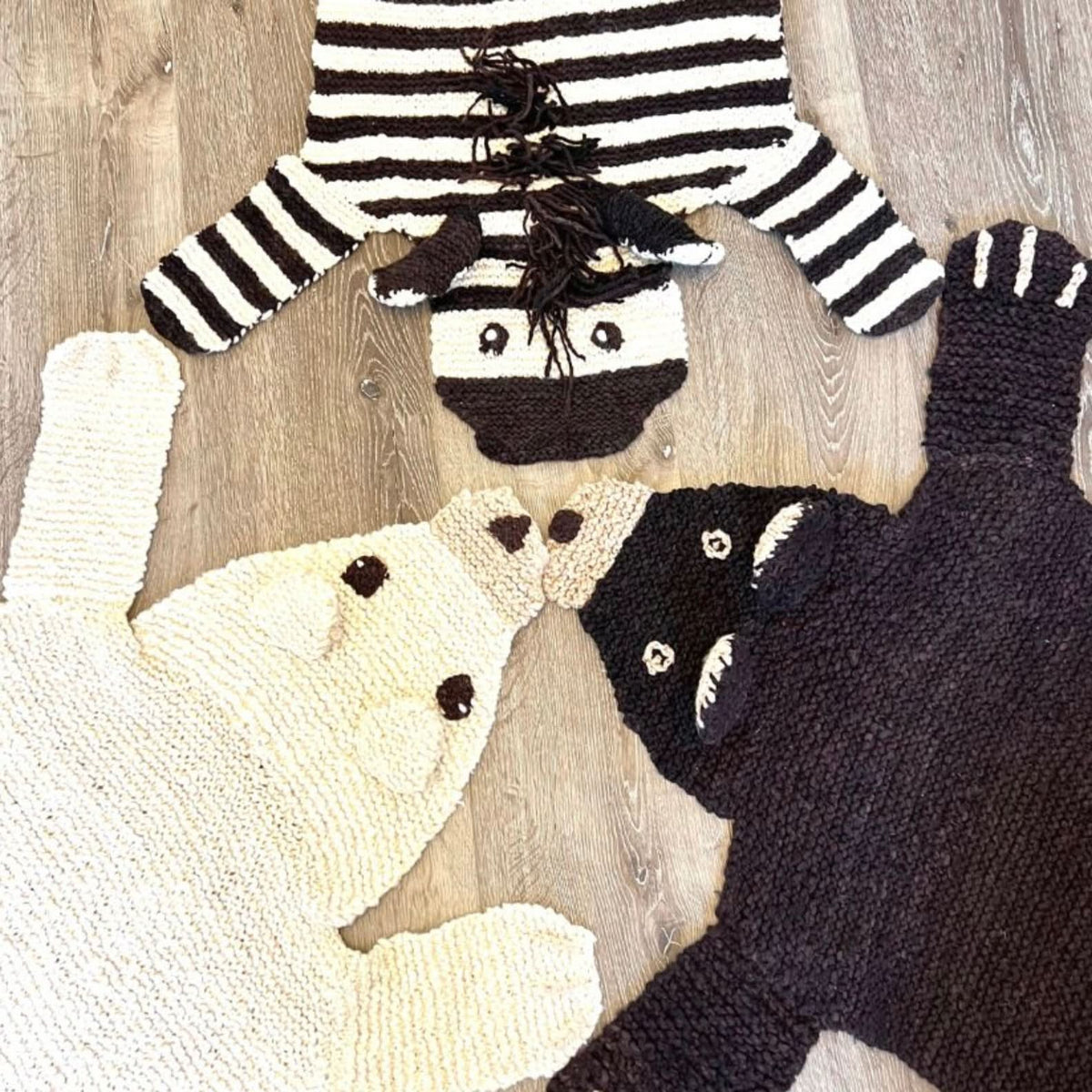 Group of animal-shaped wool play mats including polar bear