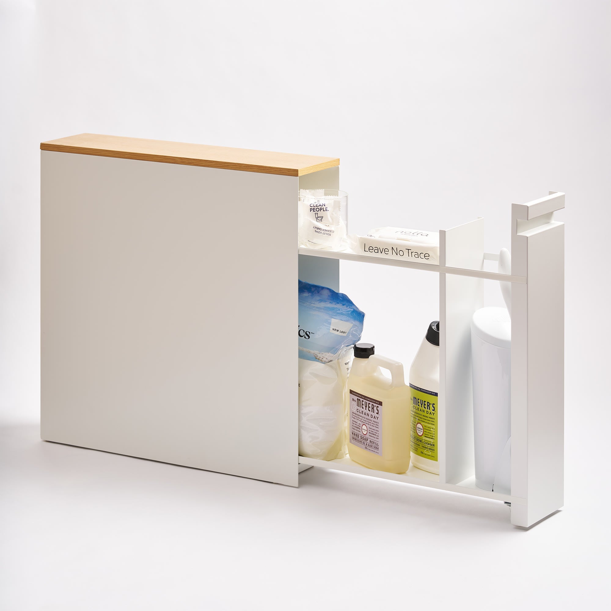 White bathroom caddy with wooden top holding cleaning supplies on a white background