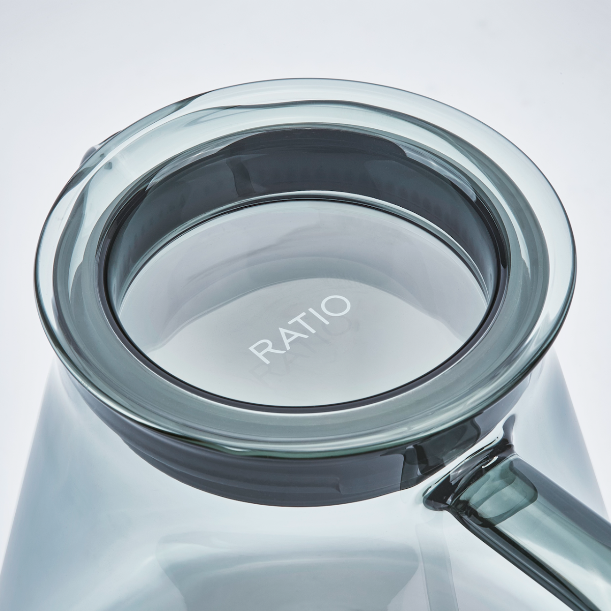 Clear glass container with 'RATIO' branding on a light gray background