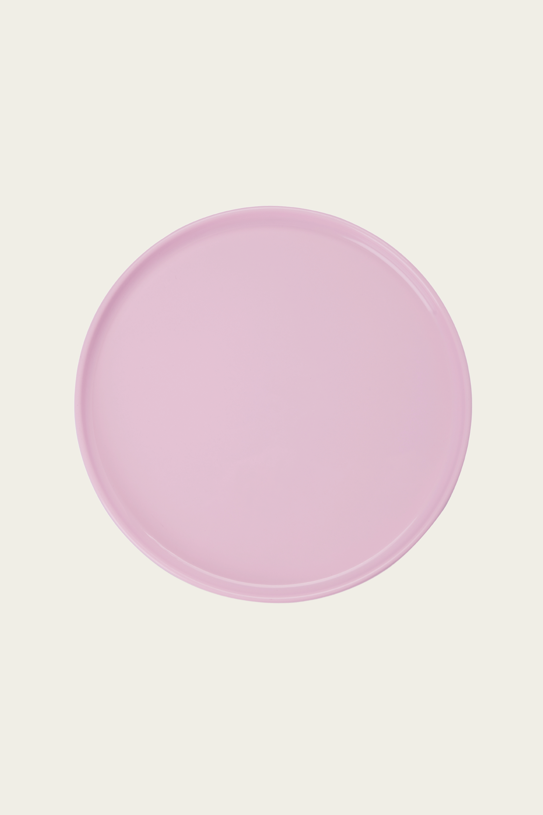 Round pink object on a light pink background