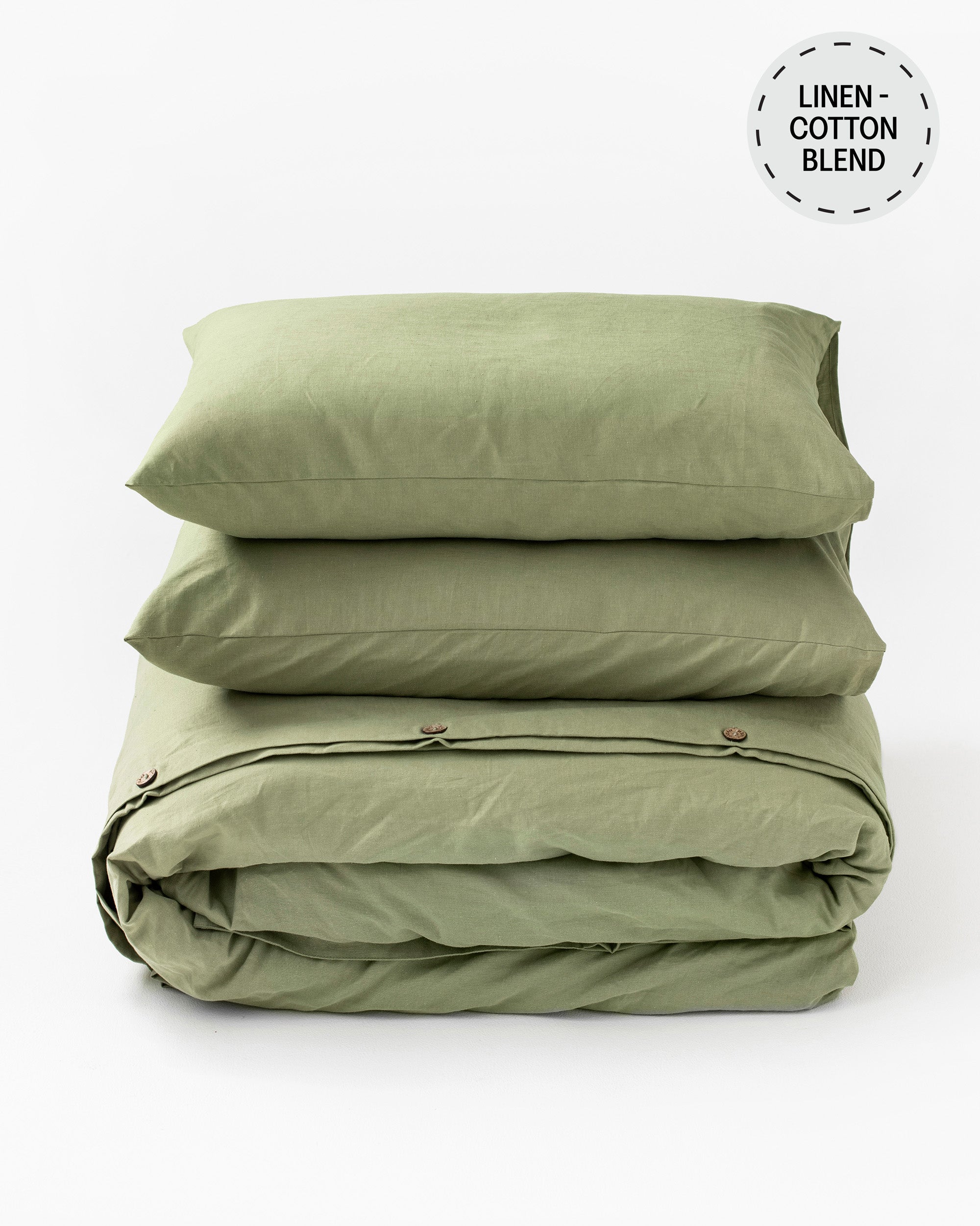 Folded green linen and cotton bedding set on a white background with 'Linen Cotton Blend' label.