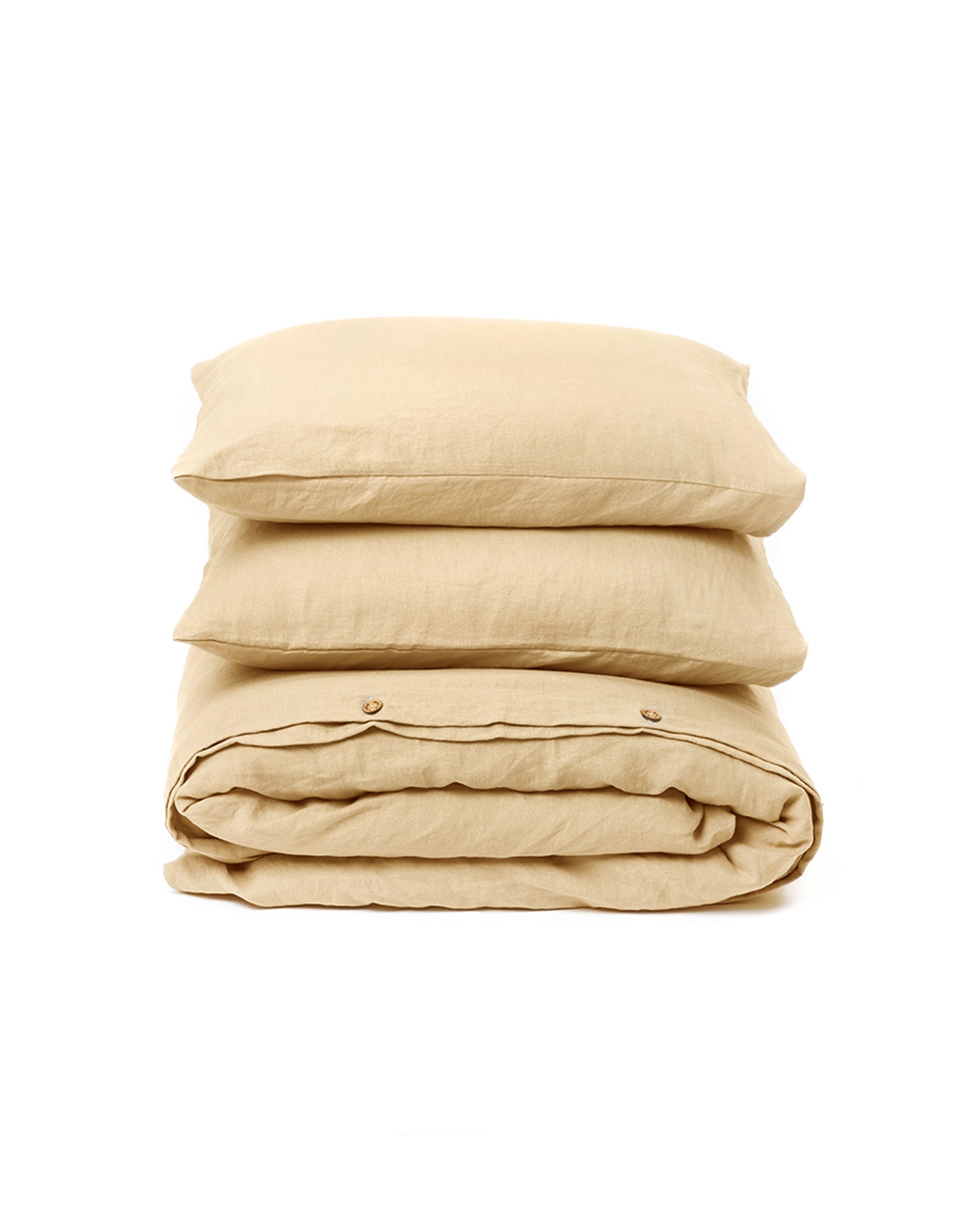 Beige bedding set with a pillow and duvet on a white background