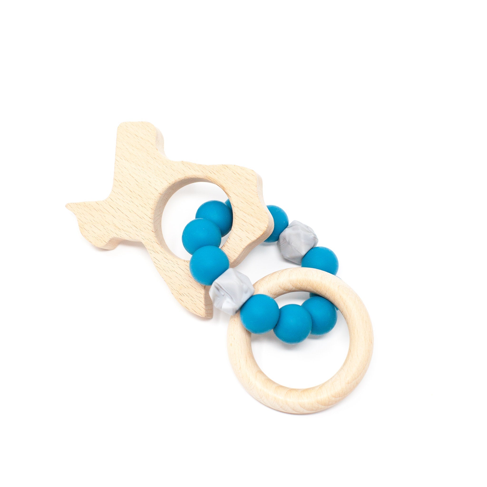 Wooden fish-shaped teether with blue silicone beads on a white background
