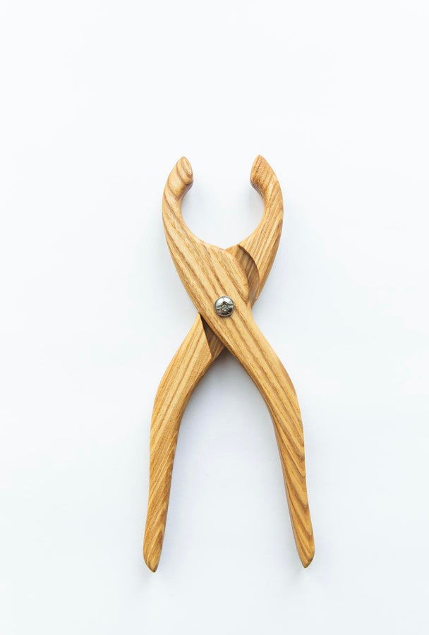 Wooden pliers on a white background